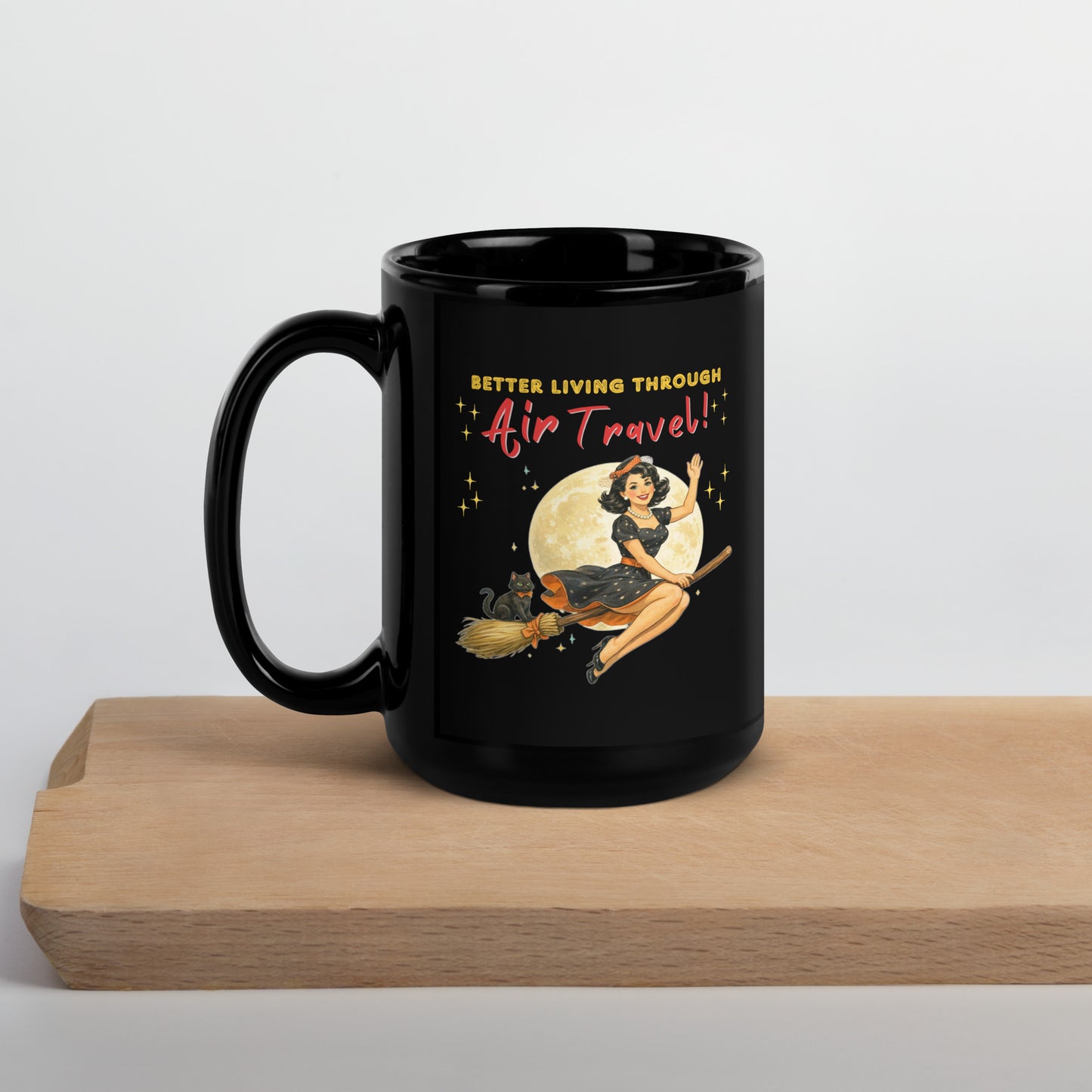 Better Living Through Air Travel black ceramic mug — vintage retro pinup witch in black polka dot dress and stewardess hat riding a broom in front of a full moon with dapper black cat familiar in orange bow tie, printed on both sides by Cinderpoint Studios
