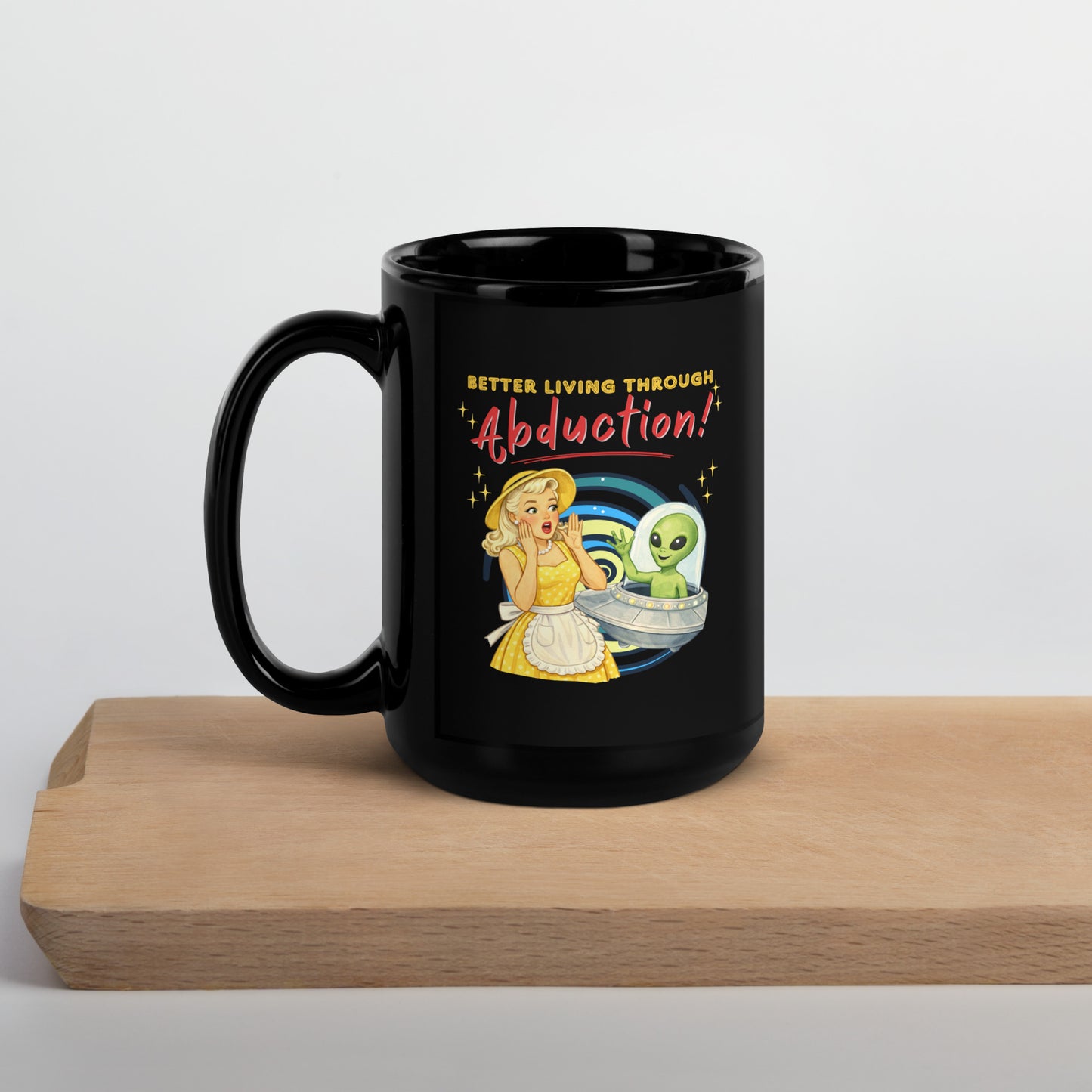 Better Living Through Abduction black ceramic mug — vintage 1950s retro blonde housewife in yellow polka dot dress reacting with delight to a friendly green alien waving from a silver saucer, printed on both sides by Cinderpoint Studios