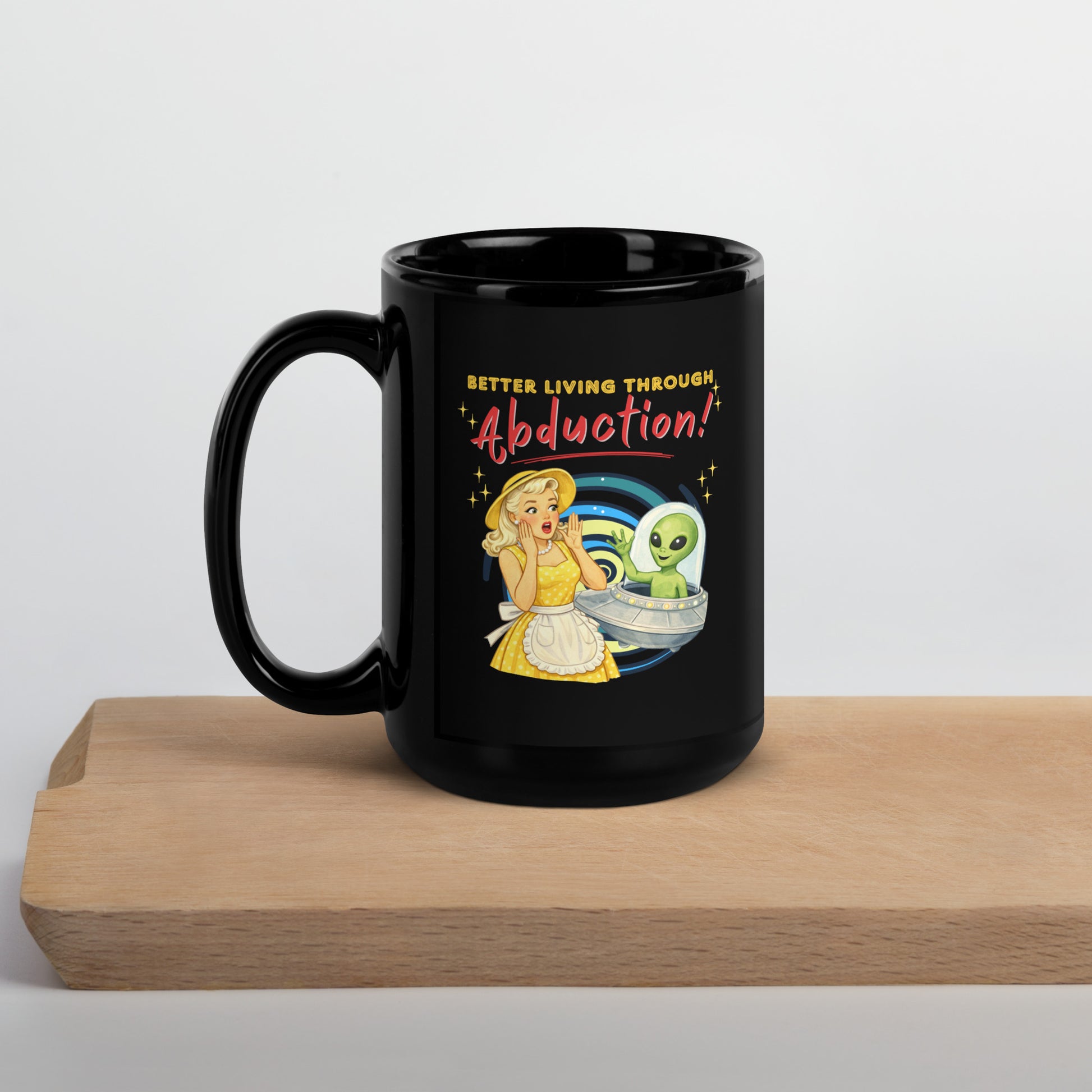 Better Living Through Abduction black ceramic mug — vintage 1950s retro blonde housewife in yellow polka dot dress reacting with delight to a friendly green alien waving from a silver saucer, printed on both sides by Cinderpoint Studios