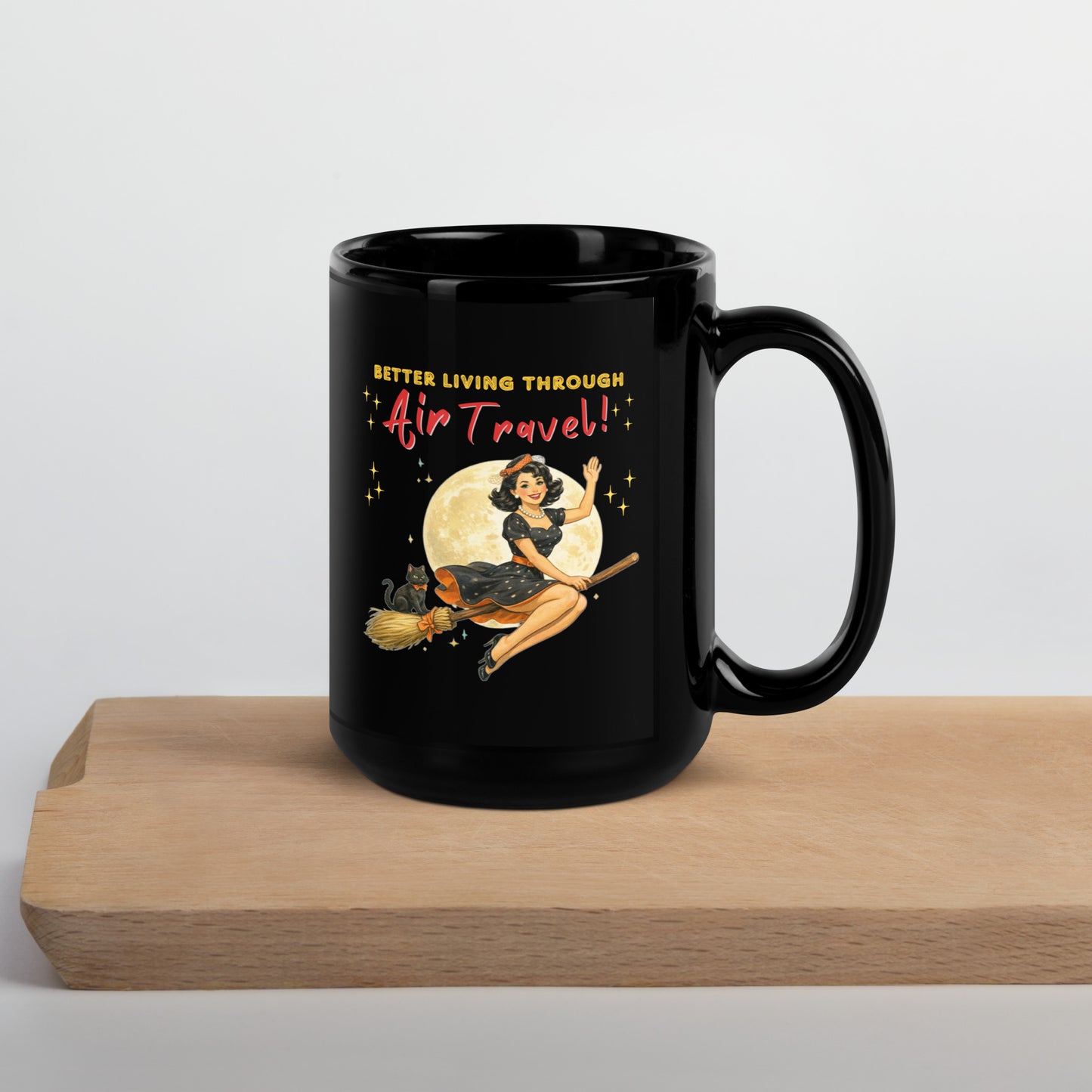 Better Living Through Air Travel black ceramic mug — vintage retro pinup witch in black polka dot dress and stewardess hat riding a broom in front of a full moon with dapper black cat familiar in orange bow tie, printed on both sides by Cinderpoint Studios