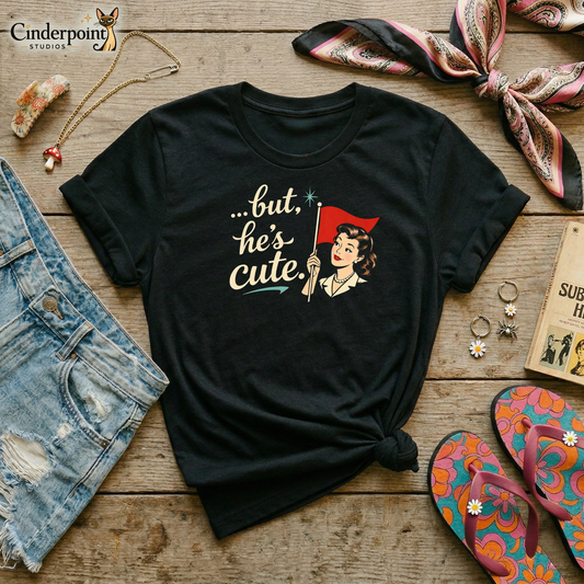 Flat layout of a black t-shirt with a 1950s pinup girl holding a red flag illustration that reads, "...but he's cute." Denim shorts, a retro hair scarf, psychedelic flip-flops, a mushroom necklace, daisy accents, and accessories surround the shirt. 