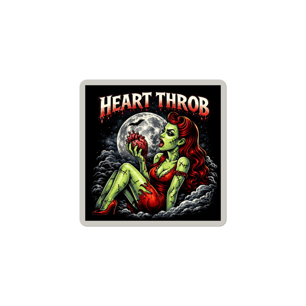 A close-up of a 3-inch square sticker featuring a red-haired zombie pinup sitting in the clouds holding a heart, with 'HEART THROB' in dripping red font above.