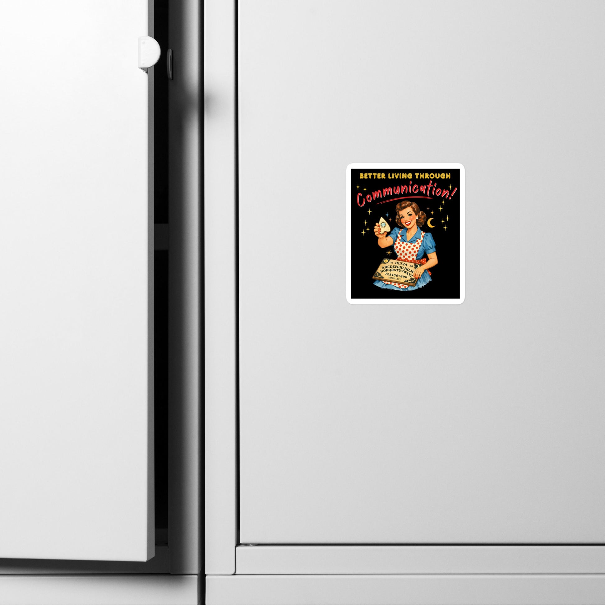 Better Living Through Communication vinyl decal on refrigerator — vintage 1950s retro housewife in polka dot apron holding ouija board and planchette on black background, satin finish waterproof sticker by Cinderpoint Studios