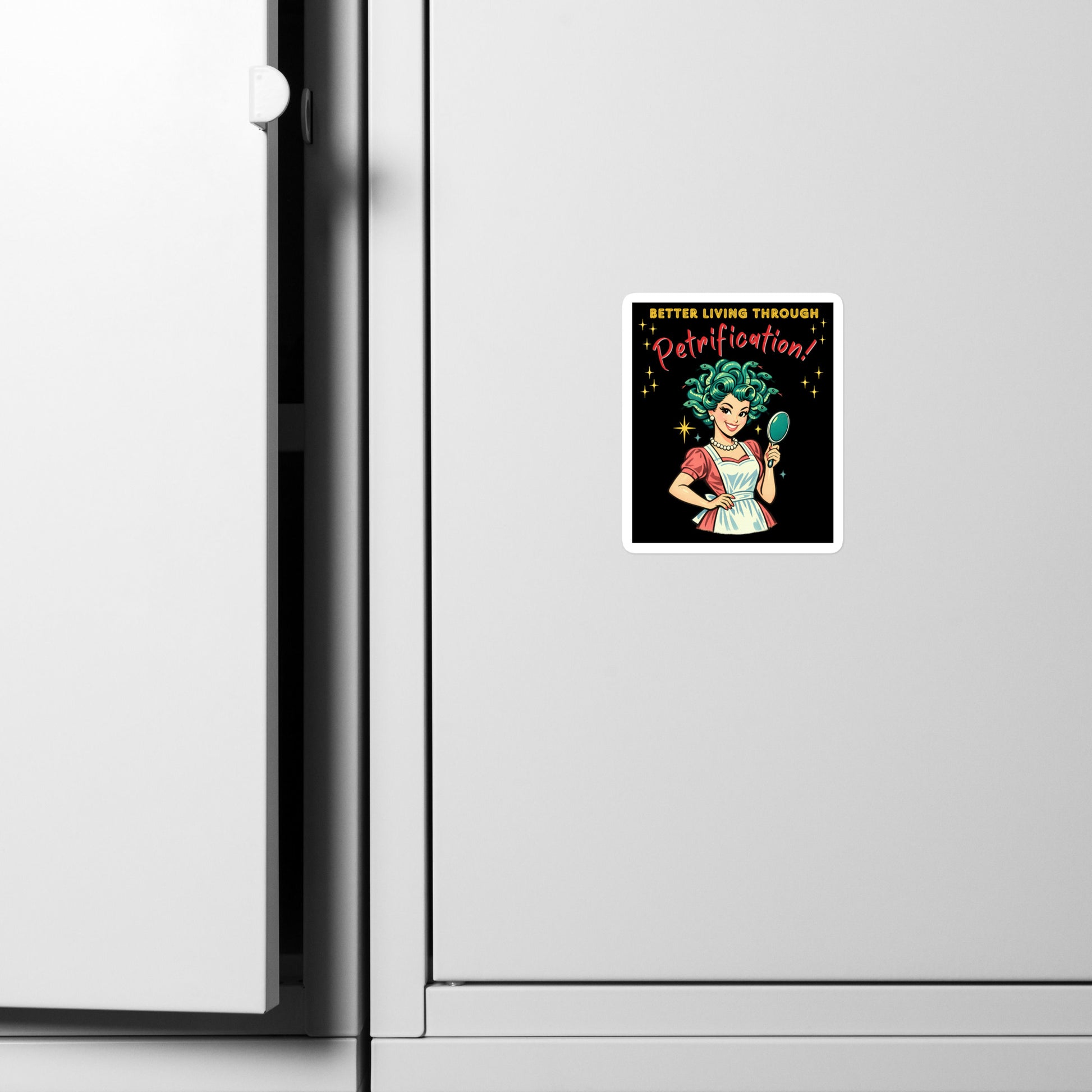 Better Living Through Petrification vinyl decal — vintage 1950s retro Medusa housewife with styled snake hair holding a hand mirror and smiling confidently in pearls and apron on black background, satin finish waterproof sticker by Cinderpoint Studios