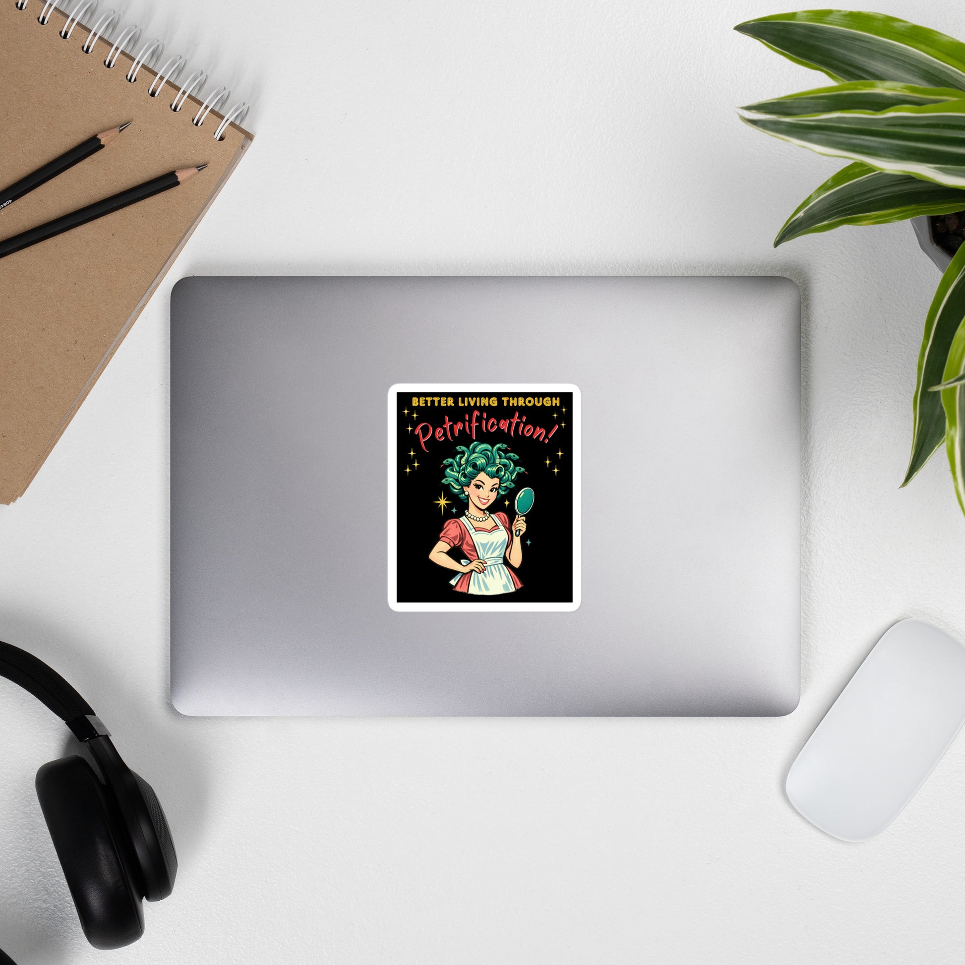 Better Living Through Petrification vinyl decal — vintage 1950s retro Medusa housewife with styled snake hair holding a hand mirror and smiling confidently in pearls and apron on black background, satin finish waterproof sticker by Cinderpoint Studios