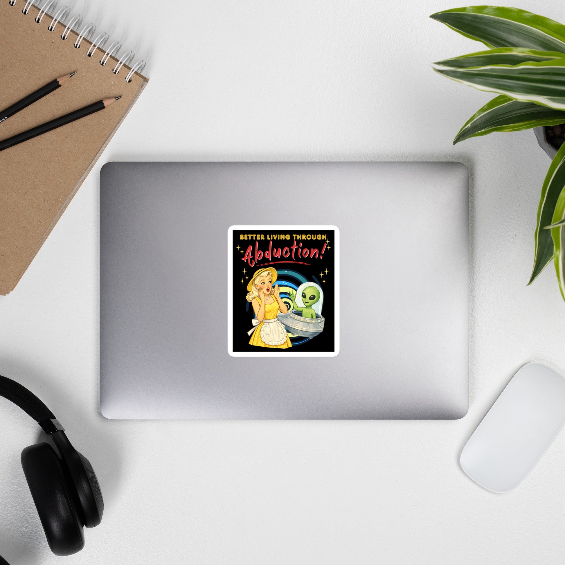 Better Living Through Abduction vinyl decal — vintage 1950s retro blonde housewife in yellow polka dot dress reacting with delight to a friendly green alien waving from a silver saucer on black background, satin finish waterproof sticker by Cinderpoint Studios