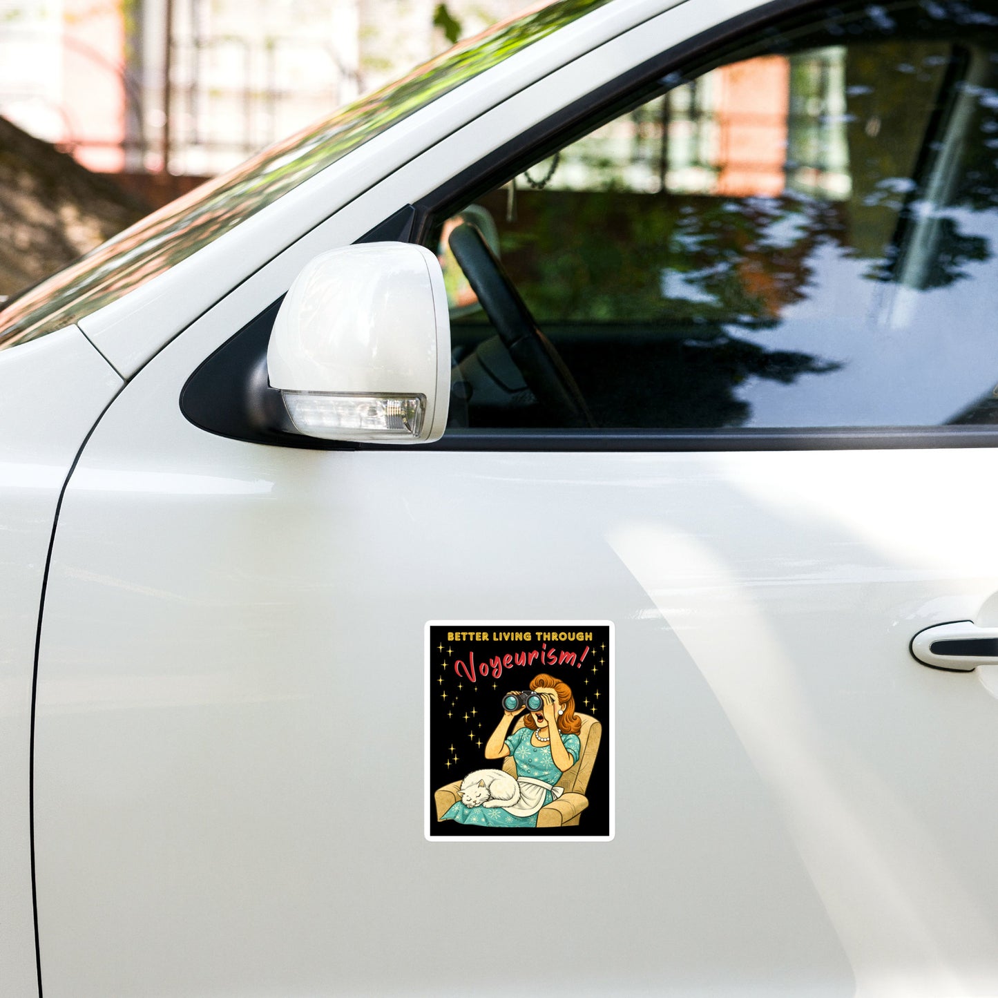 Better Living Through Voyeurism vinyl decal — vintage 1950s retro housewife peering through binoculars with mouth open while white cat sleeps in her lap on black background, satin finish waterproof sticker by Cinderpoint Studios