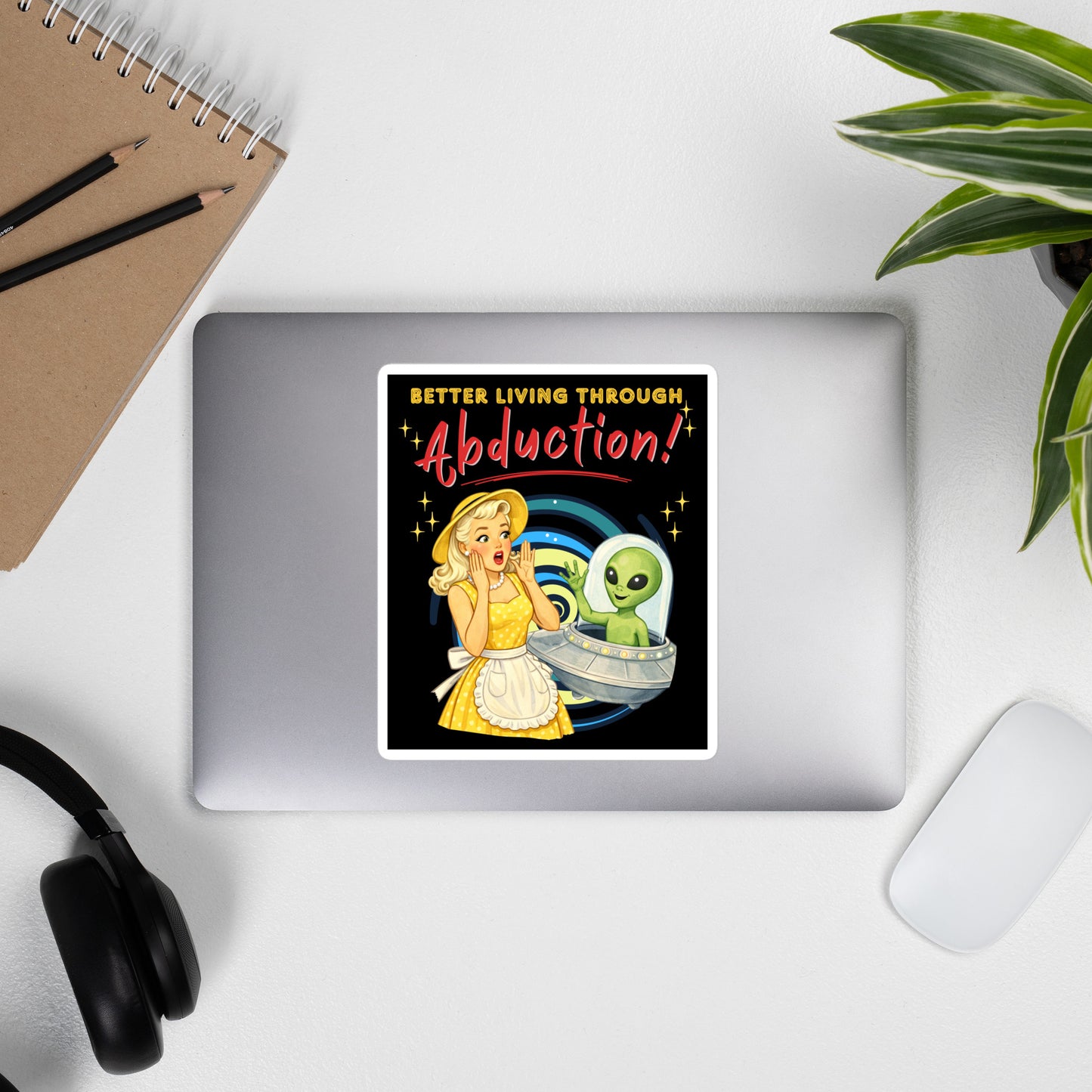 Better Living Through Abduction vinyl decal — vintage 1950s retro blonde housewife in yellow polka dot dress reacting with delight to a friendly green alien waving from a silver saucer on black background, satin finish waterproof sticker by Cinderpoint Studios