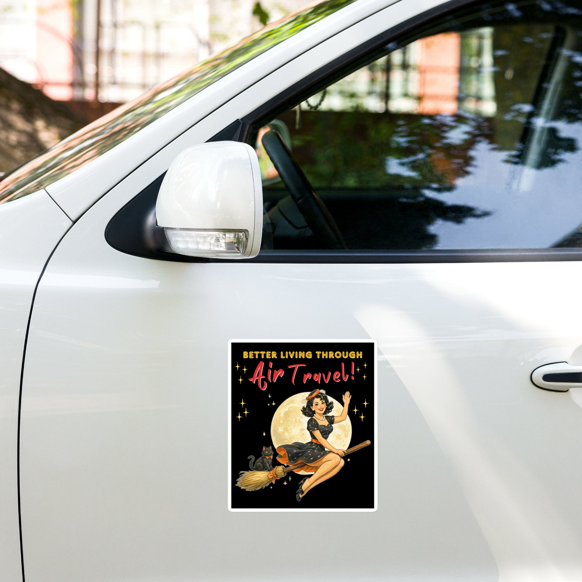 Better Living Through Air Travel vinyl decal — vintage retro pinup witch in black polka dot dress and stewardess hat riding a broom in front of a full moon with dapper black cat familiar in orange bow tie on black background, satin finish waterproof sticker by Cinderpoint Studios