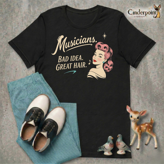 Black Bella+Canvas 3001 graphic tee featuring a retro woman with pink hair and the phrase “Musicians. Bad Idea. Great Hair.”
