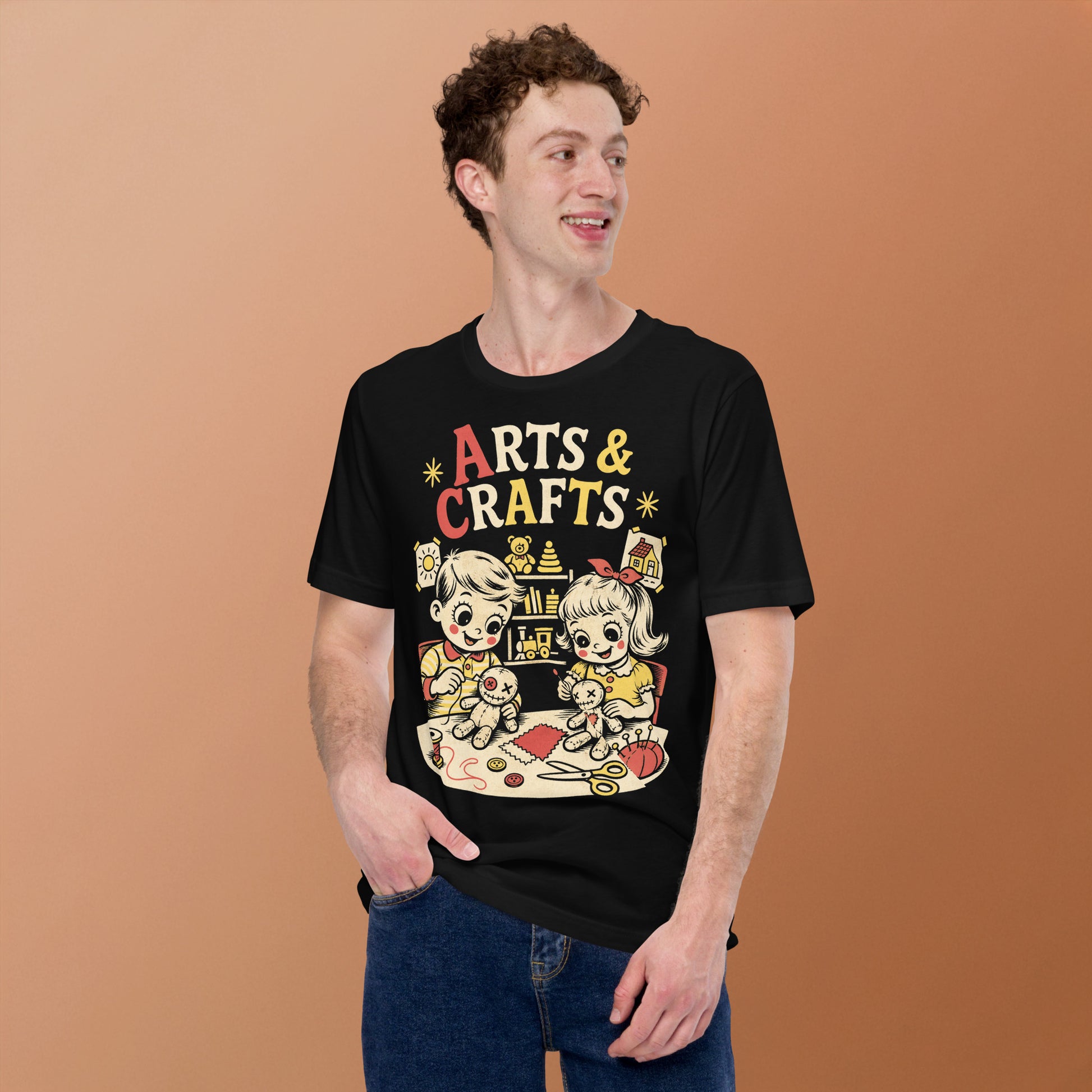 A retro-style graphic t-shirt featuring a creepy-cute voodoo doll with "Arts & Crafts" in stylized, vintage-inspired lettering, perfect for dark humor and goth fans.