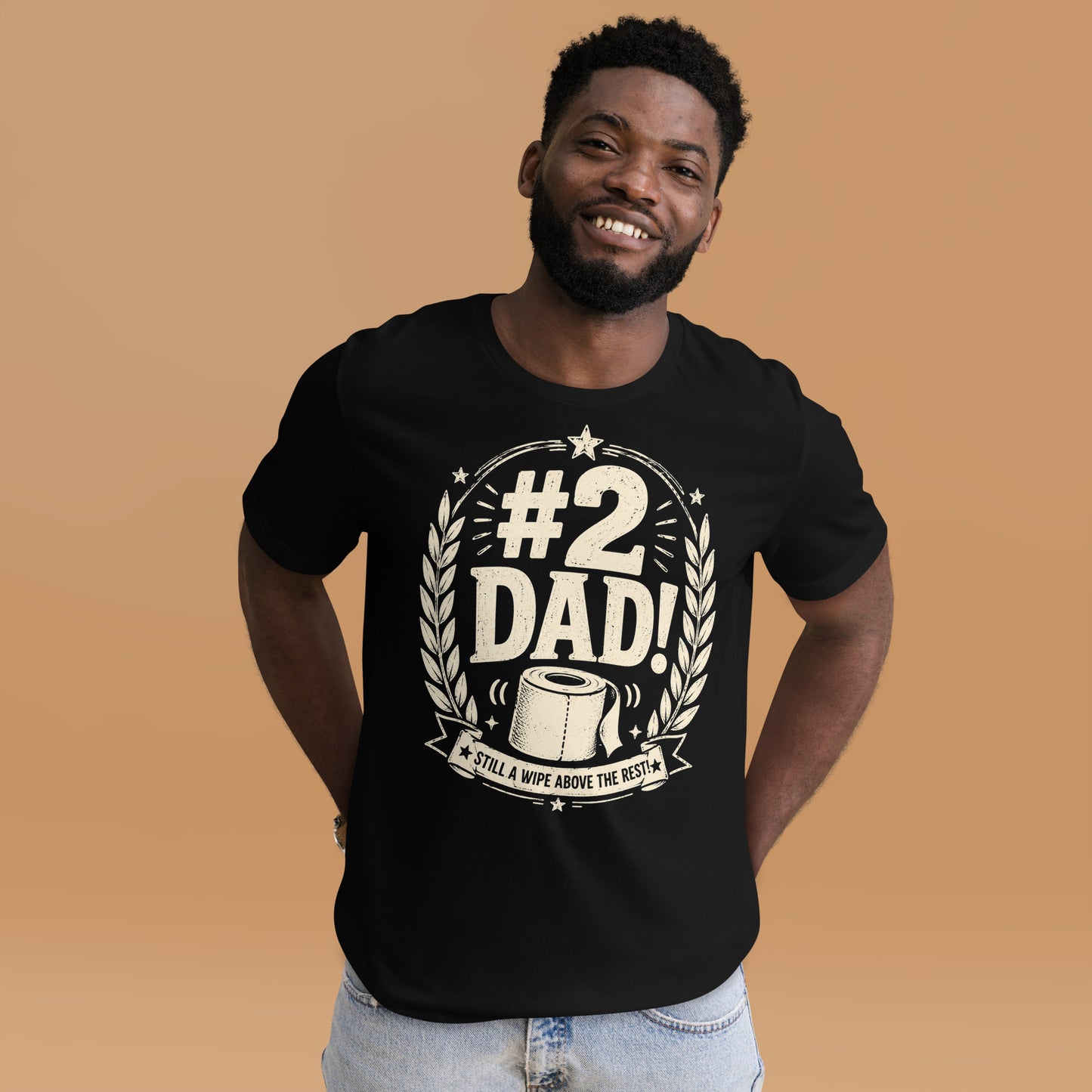 Man wearing a black graphic tee featuring original Cinderpoint Studios artwork for #2 Dad, a one-color funny dad design with bold retro lettering, laurel accents, stars, a toilet paper roll illustration, and the phrase Still a Wipe Above the Rest!