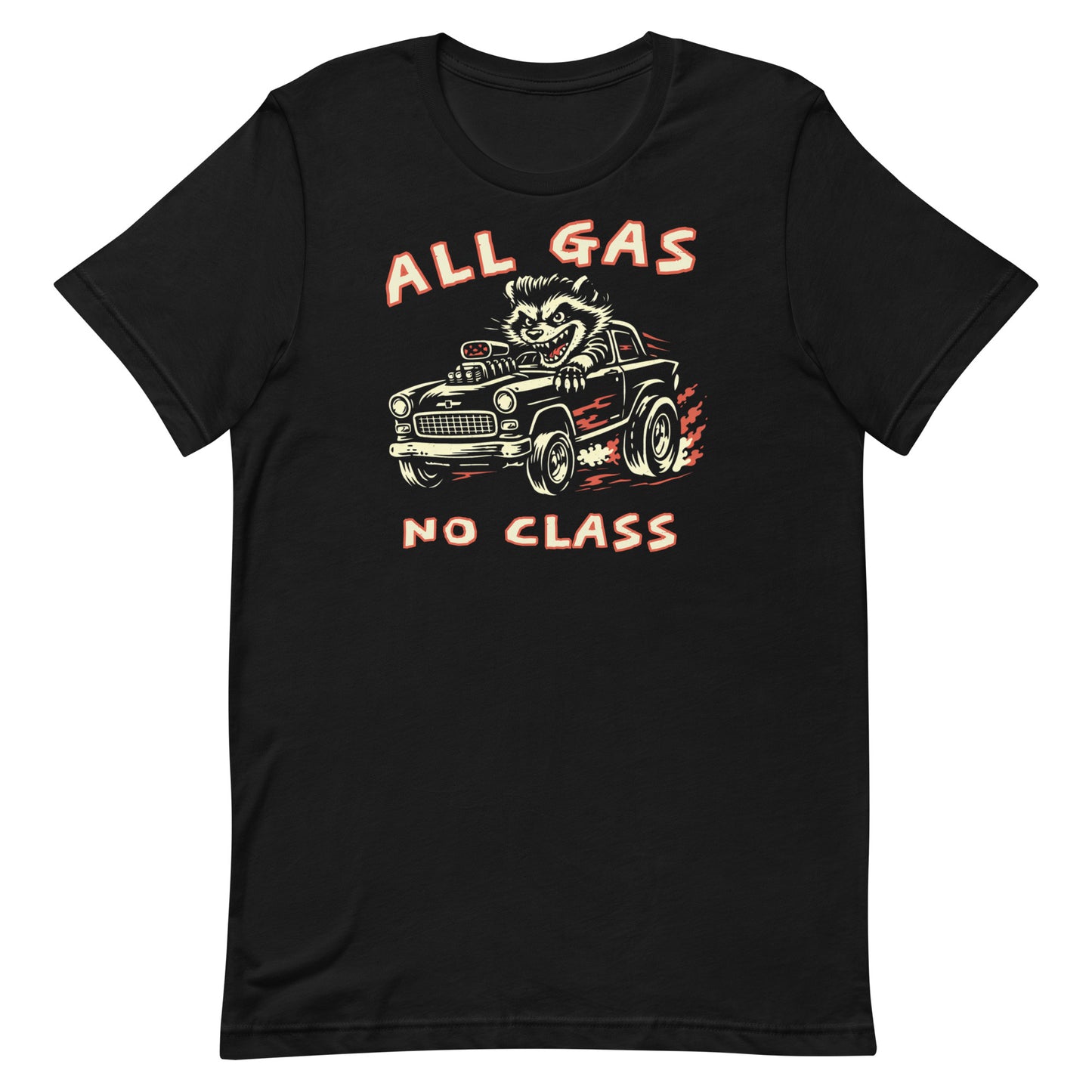 A top-down photograph of a premium black t-shirt on a weathered wooden workbench. The shirt features a two-color distressed graphic of a pompadoured raccoon driving a high-performance rat rod with the text "ALL GAS NO CLASS."