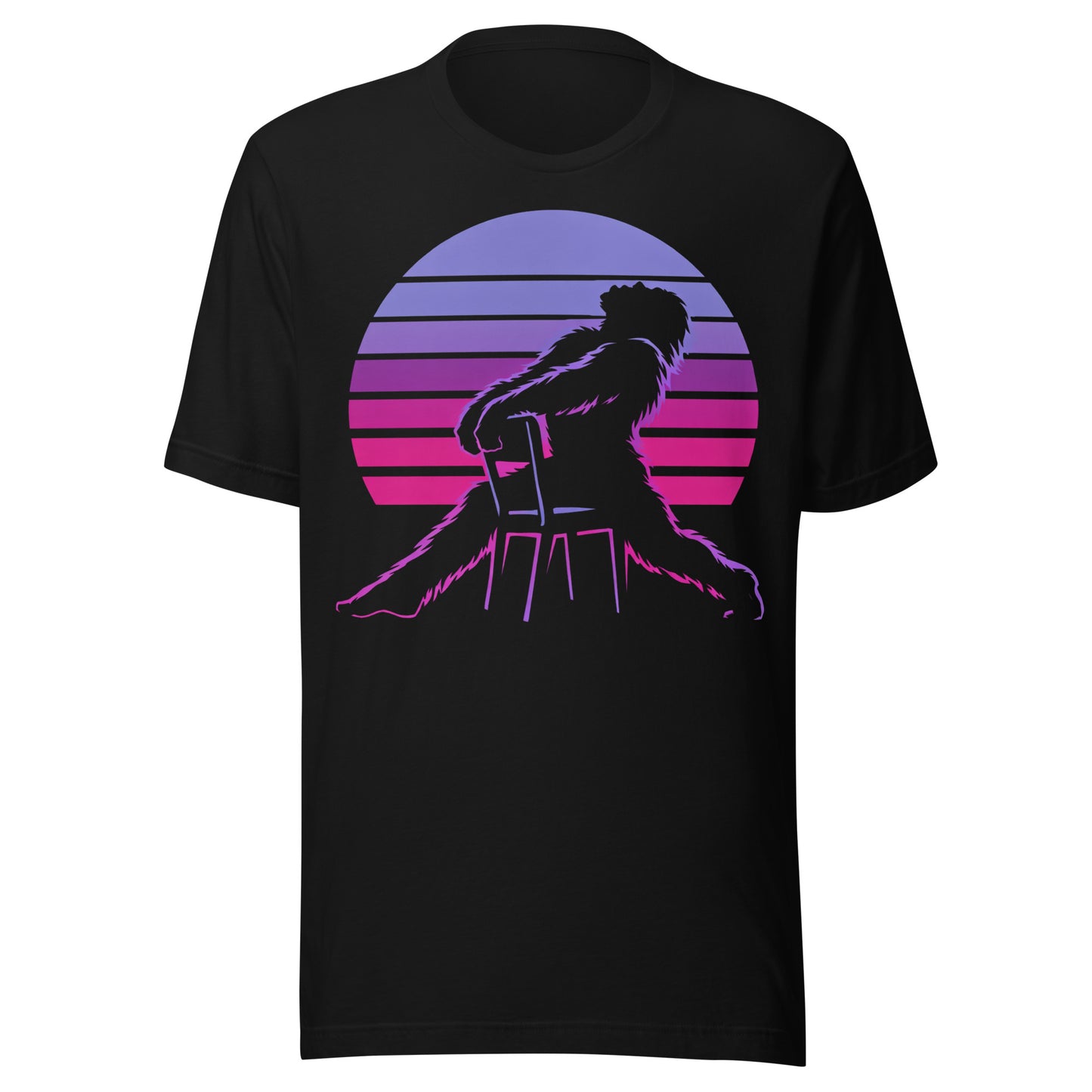 A retro graphic t-shirt featuring the cryptid Bigfoot in the iconic Flashdance chair-pose silhouette against a vibrant 1980s-style sunset.