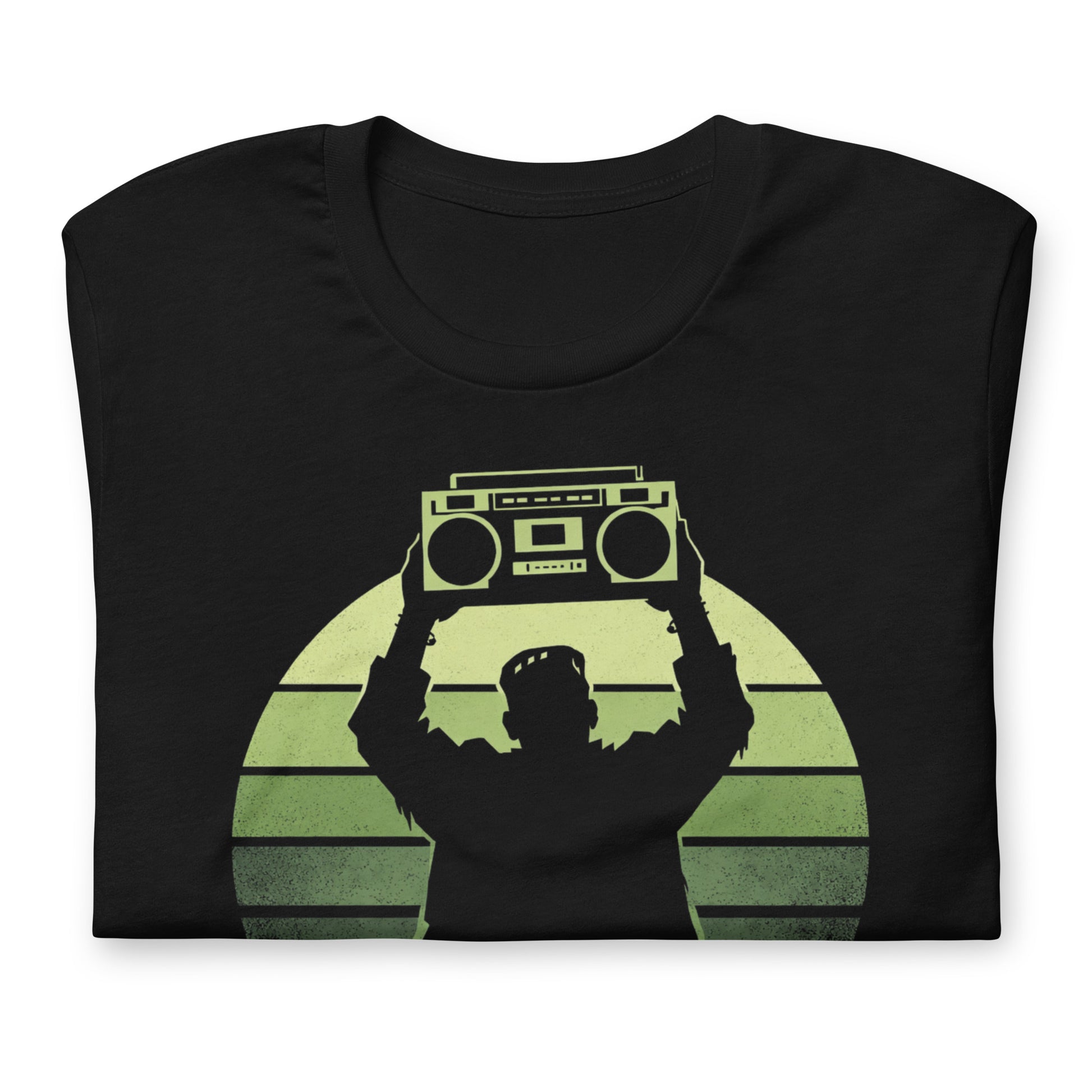 A retro-style graphic t-shirt featuring Frankenstein’s monster holding a 1980s boombox over his head in the iconic Say Anything movie pose, set against a vibrant neon sunburst.