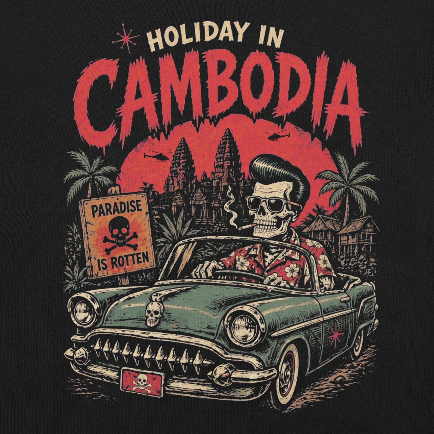A detailed lowbrow graphic on a black t-shirt featuring a skeleton with a pompadour driving a 1955 Chevy convertible. The background shows Angkor Wat under a red sun with helicopters, and a sign that reads 'Paradise is Rotten'.