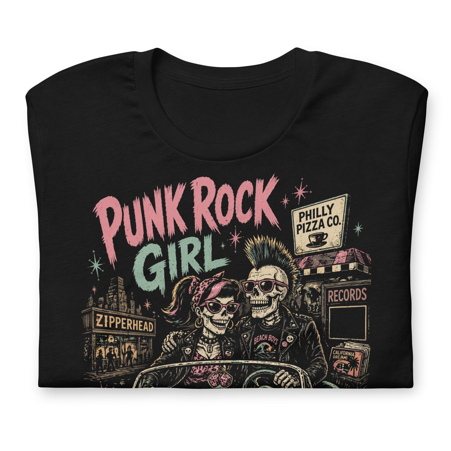 A retro-style graphic on a black t-shirt featuring two skeletons—a male with a mohawk and a female with a pink bow—driving a teal 1955 Chevy past iconic Philadelphia punk landmarks.