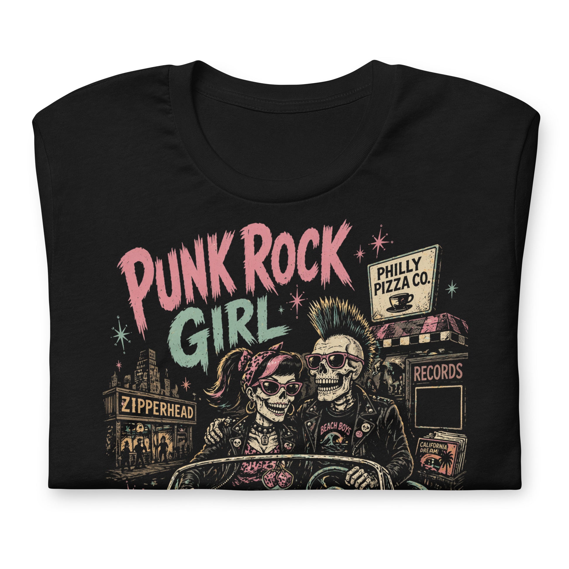 A retro-style graphic on a black t-shirt featuring two skeletons—a male with a mohawk and a female with a pink bow—driving a teal 1955 Chevy past iconic Philadelphia punk landmarks.