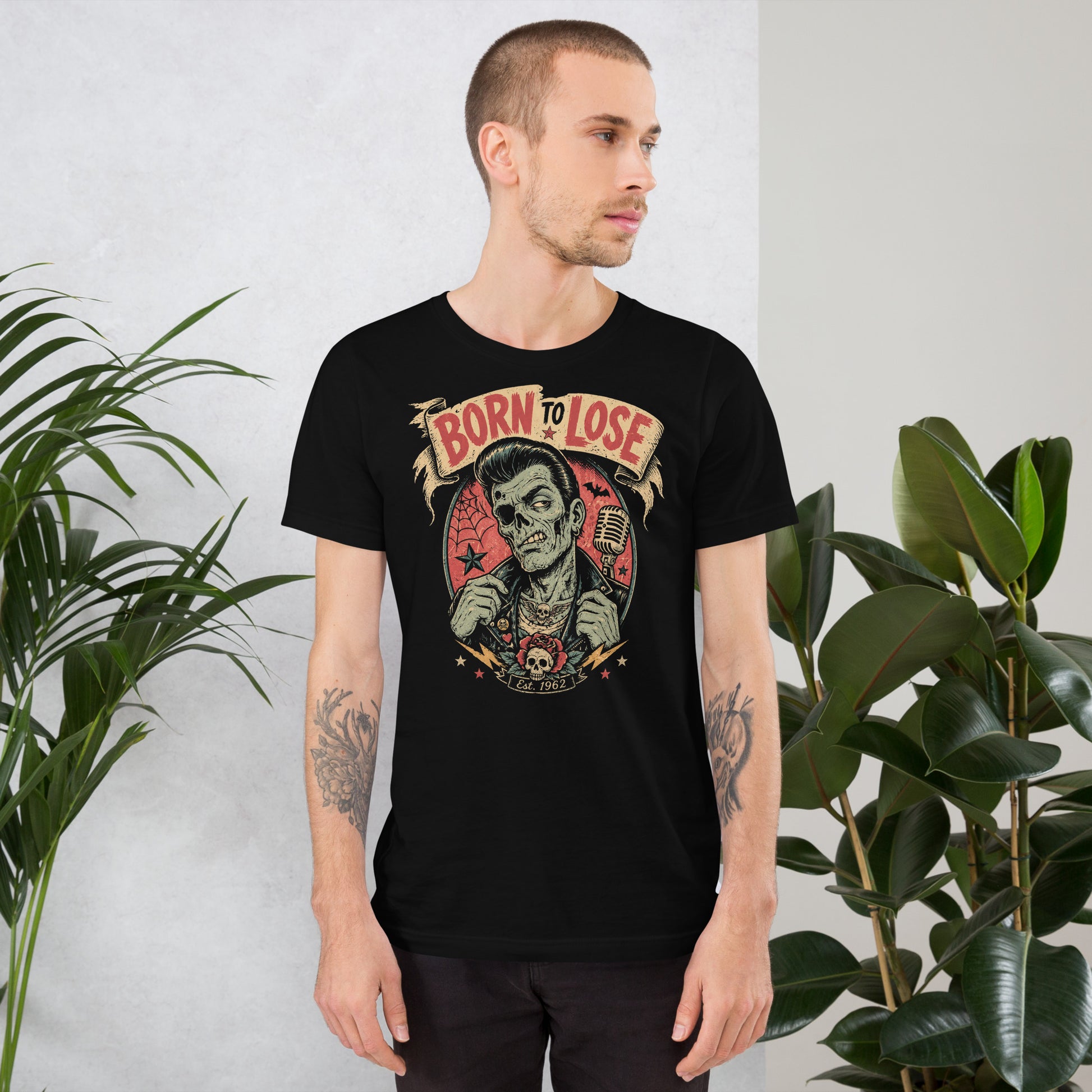 Young man wearing A vintage tattoo flash-style graphic on a black t-shirt featuring a green-skinned zombie monster with a banner that says "Born to Lose"