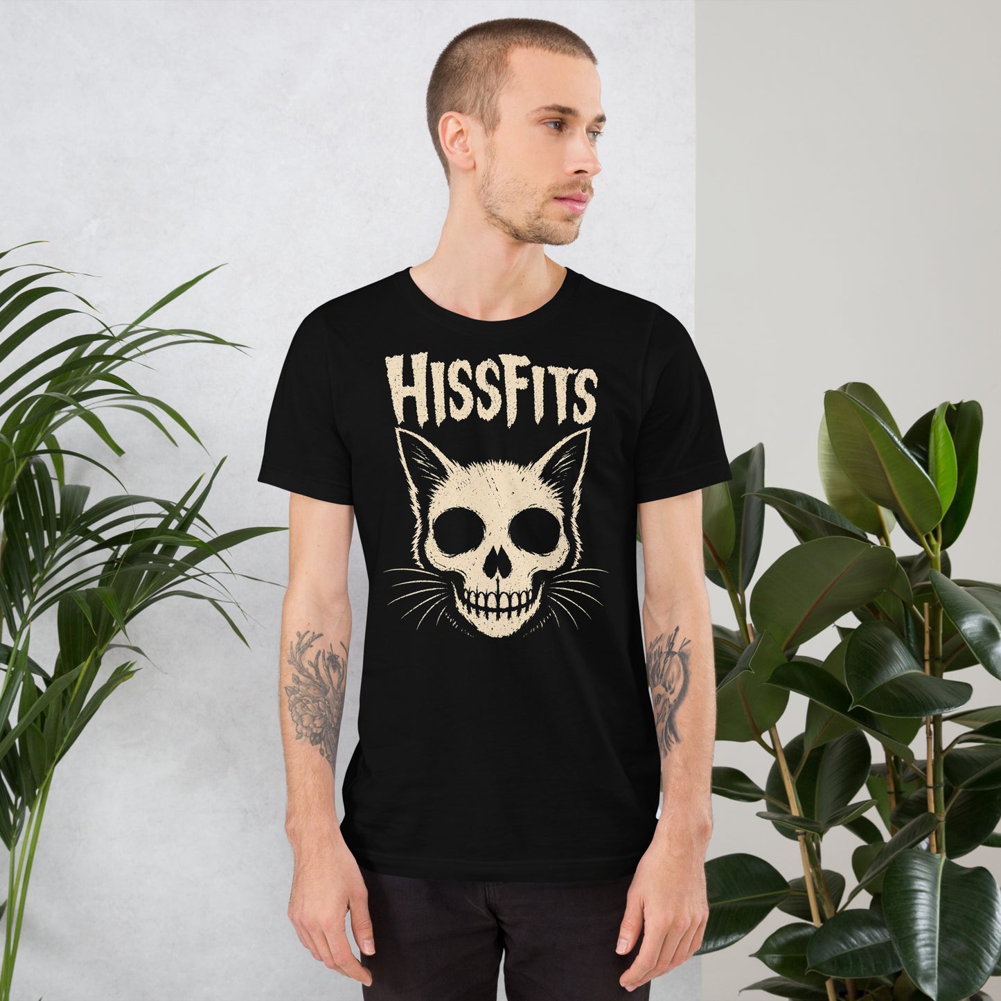 A retro horror-style graphic on a black t-shirt featuring a stylized cat skull with whiskers and pointed ears, with "HISSFITS" in iconic distressed punk-rock lettering.