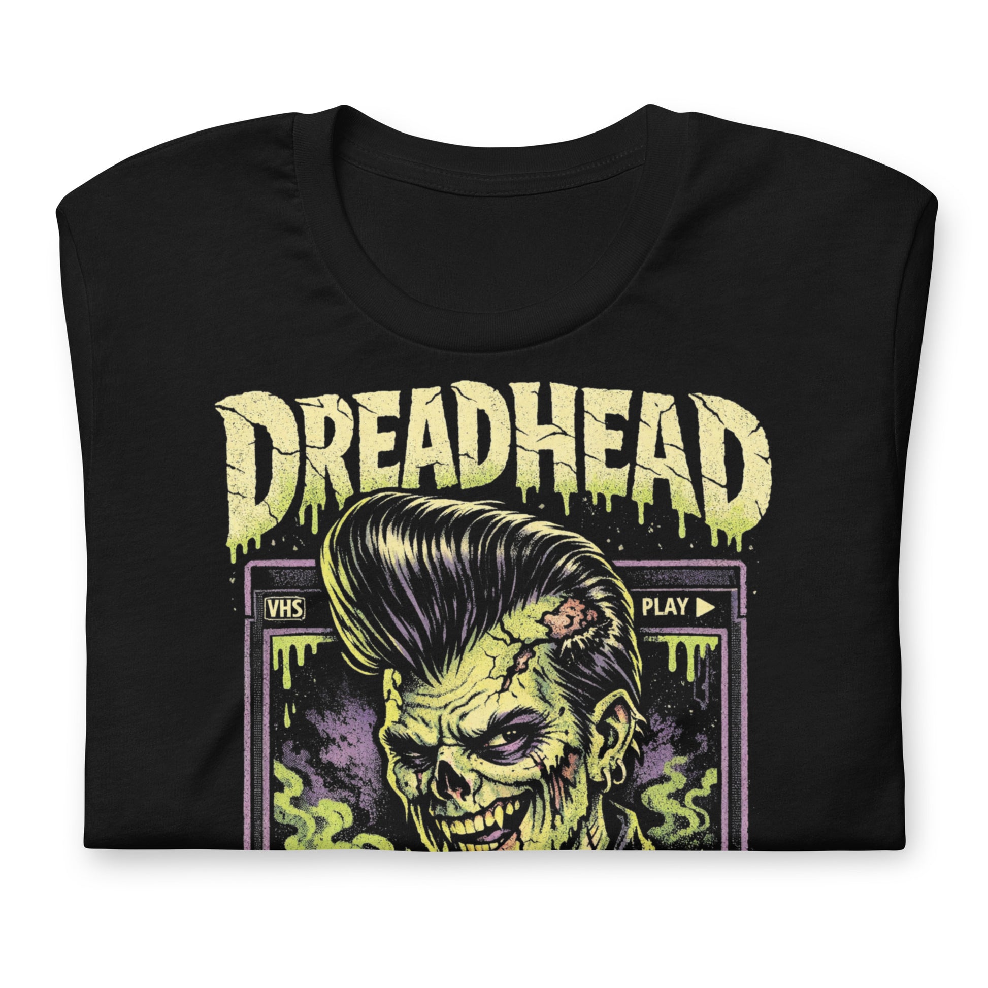 A retro 80s horror-style graphic on a black t-shirt featuring a zombie greaser with a pompadour and "Dreadhead" and "Rewind Repeat" in distressed VHS-style lettering.