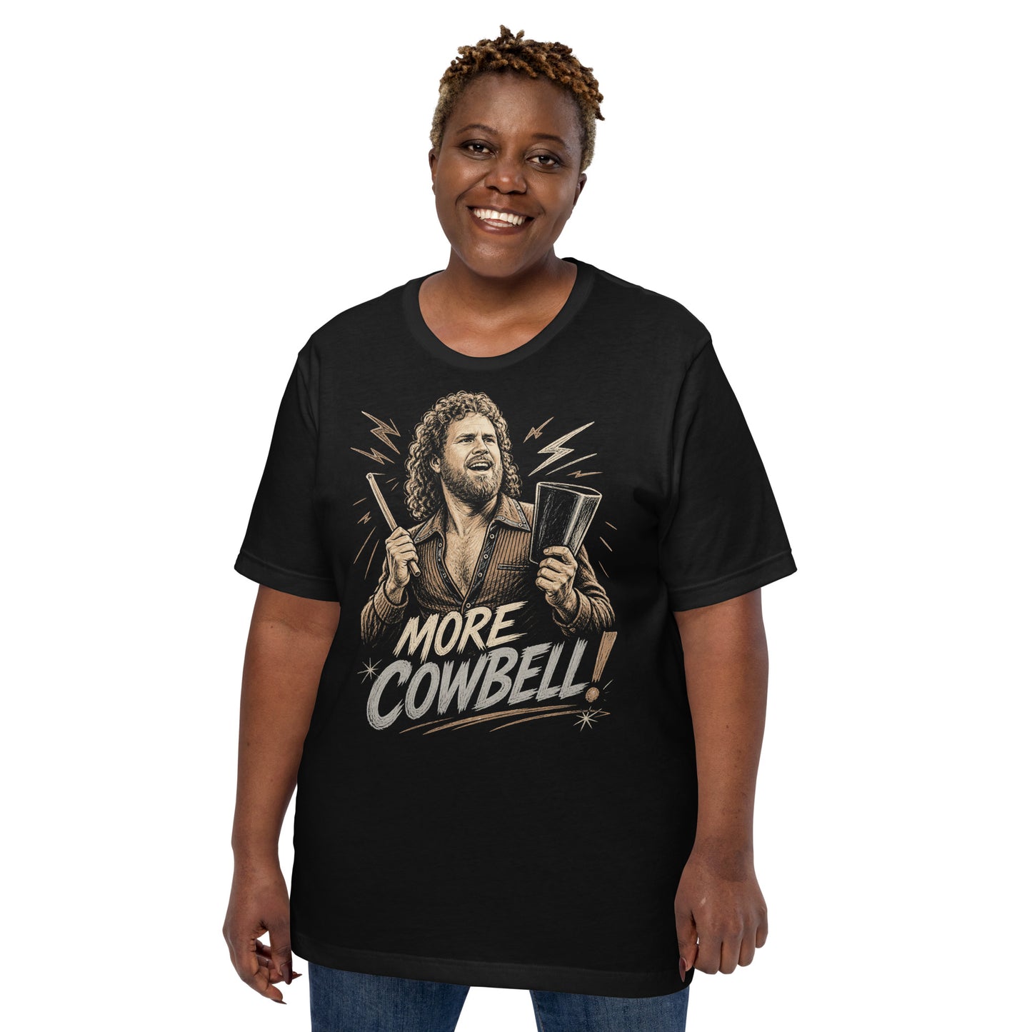 A gritty, woodcut-style illustration on a black t-shirt featuring a bearded man with curly hair and an open-collared 70s shirt holding a cowbell and drumstick, with the text 'MORE COWBELL!' in a distressed font.