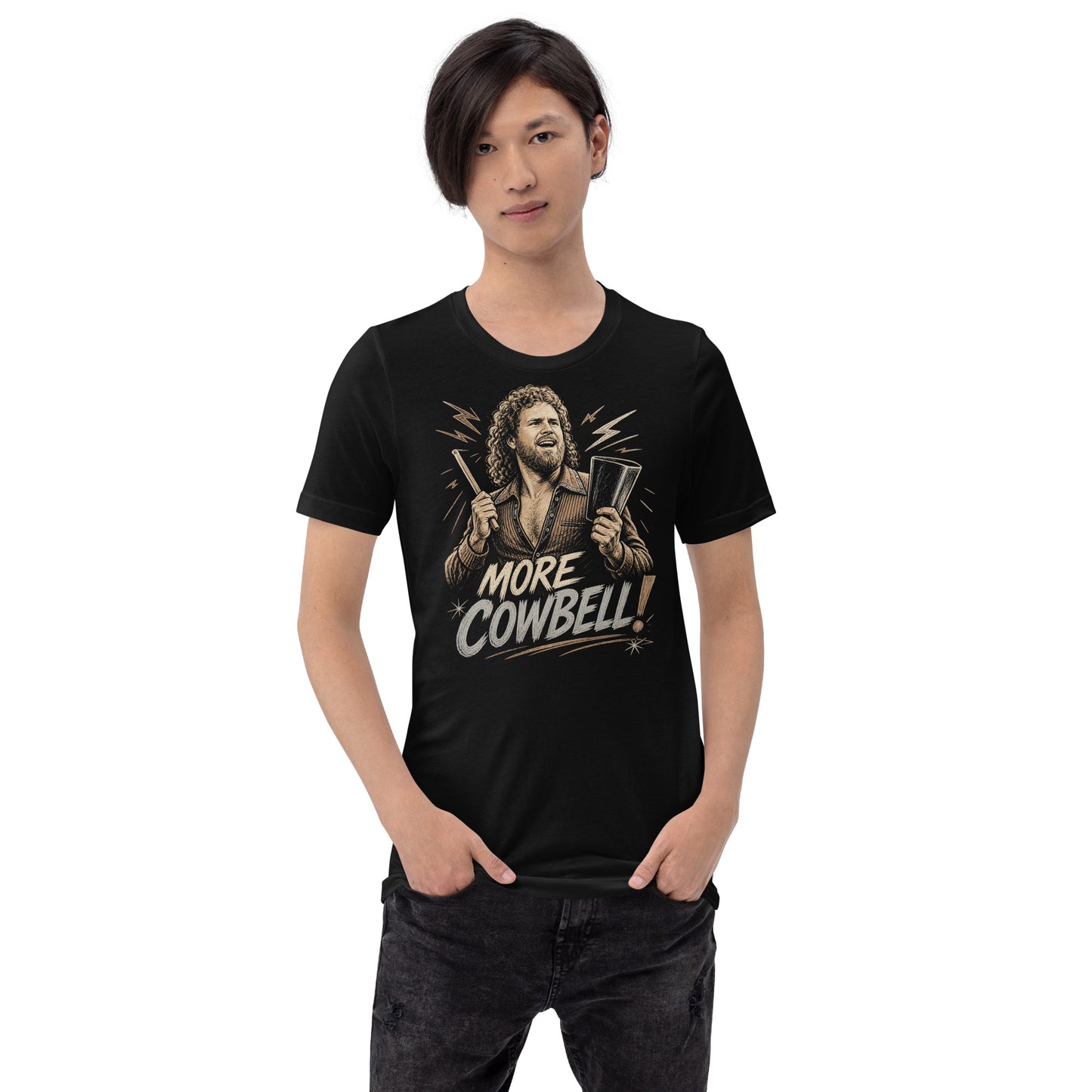 A gritty, woodcut-style illustration on a black t-shirt featuring a bearded man with curly hair and an open-collared 70s shirt holding a cowbell and drumstick, with the text 'MORE COWBELL!' in a distressed font.