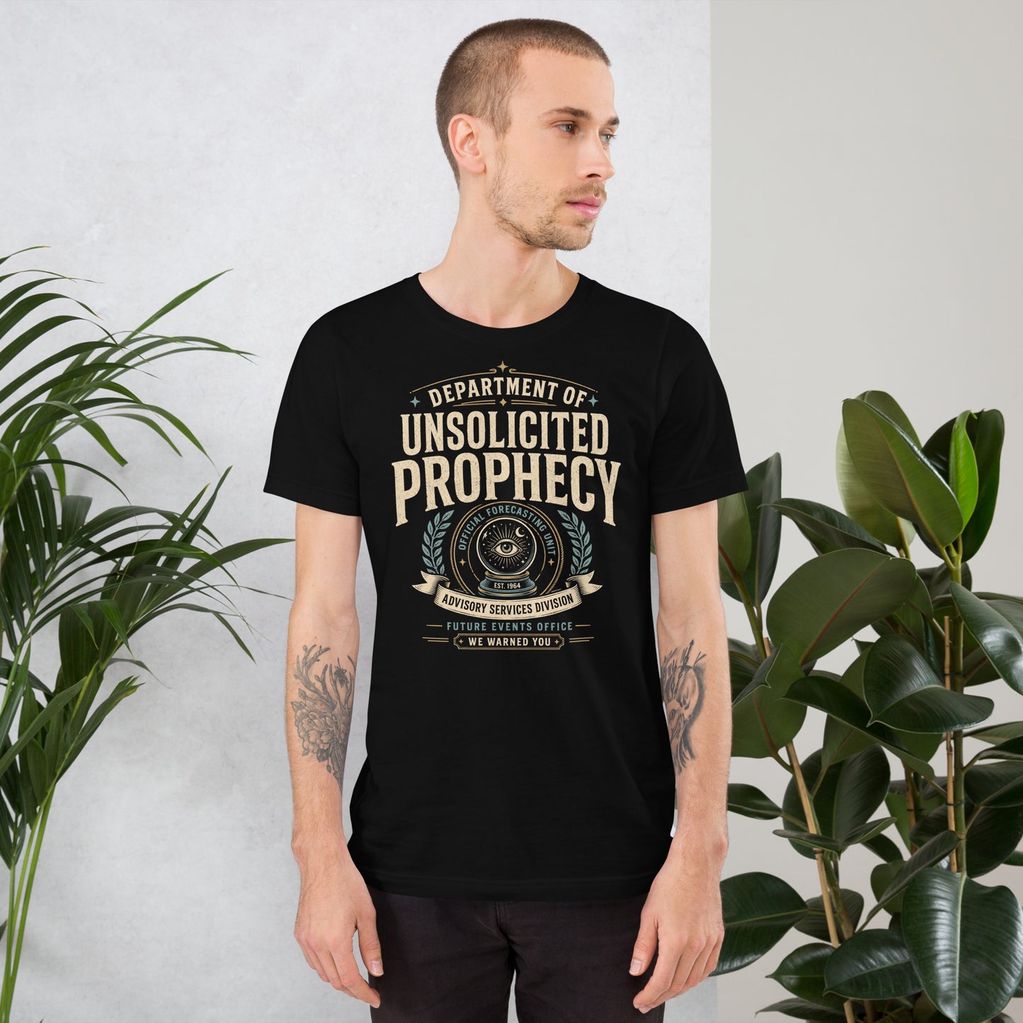 Male lifestyle mockup wearing black Department of Unsolicited Prophecy t-shirt with retro occult forecasting graphic by Cinderpoint Studios