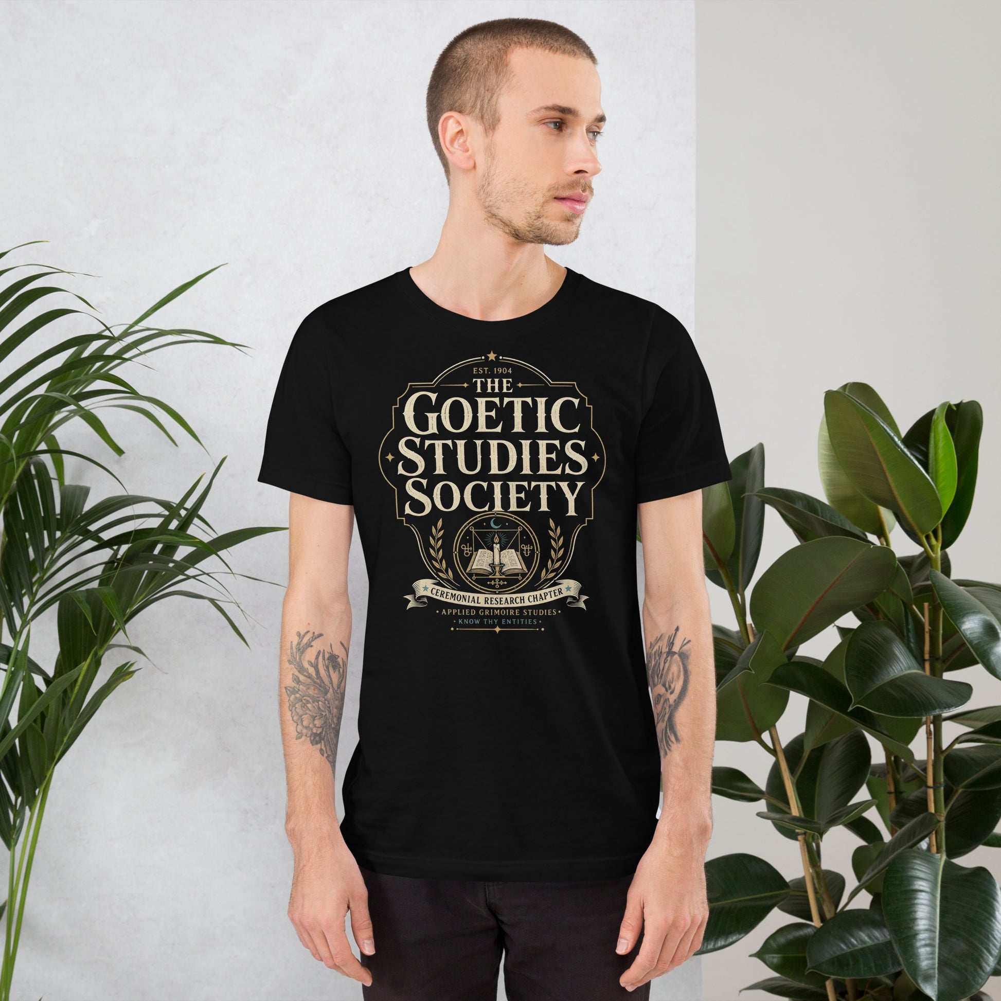 The Goetic Studies Society shirt with cream, gold, and teal vintage-style graphic on black tee