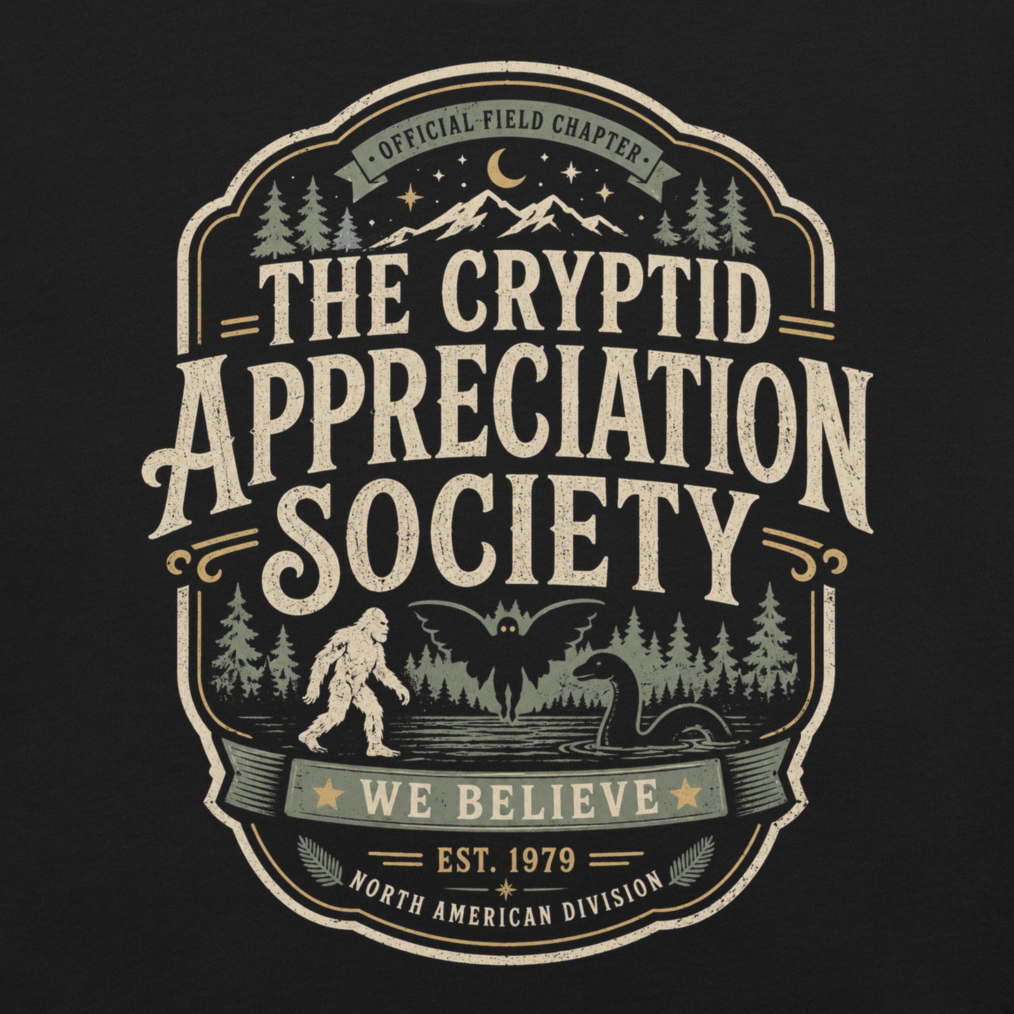 Black graphic tee featuring original Cinderpoint Studios artwork for The Cryptid Appreciation Society, a retro cryptid badge design with Sasquatch, Mothman, a Nessie-style lake creature, forest, mountains, moon, stars, and We Believe text.