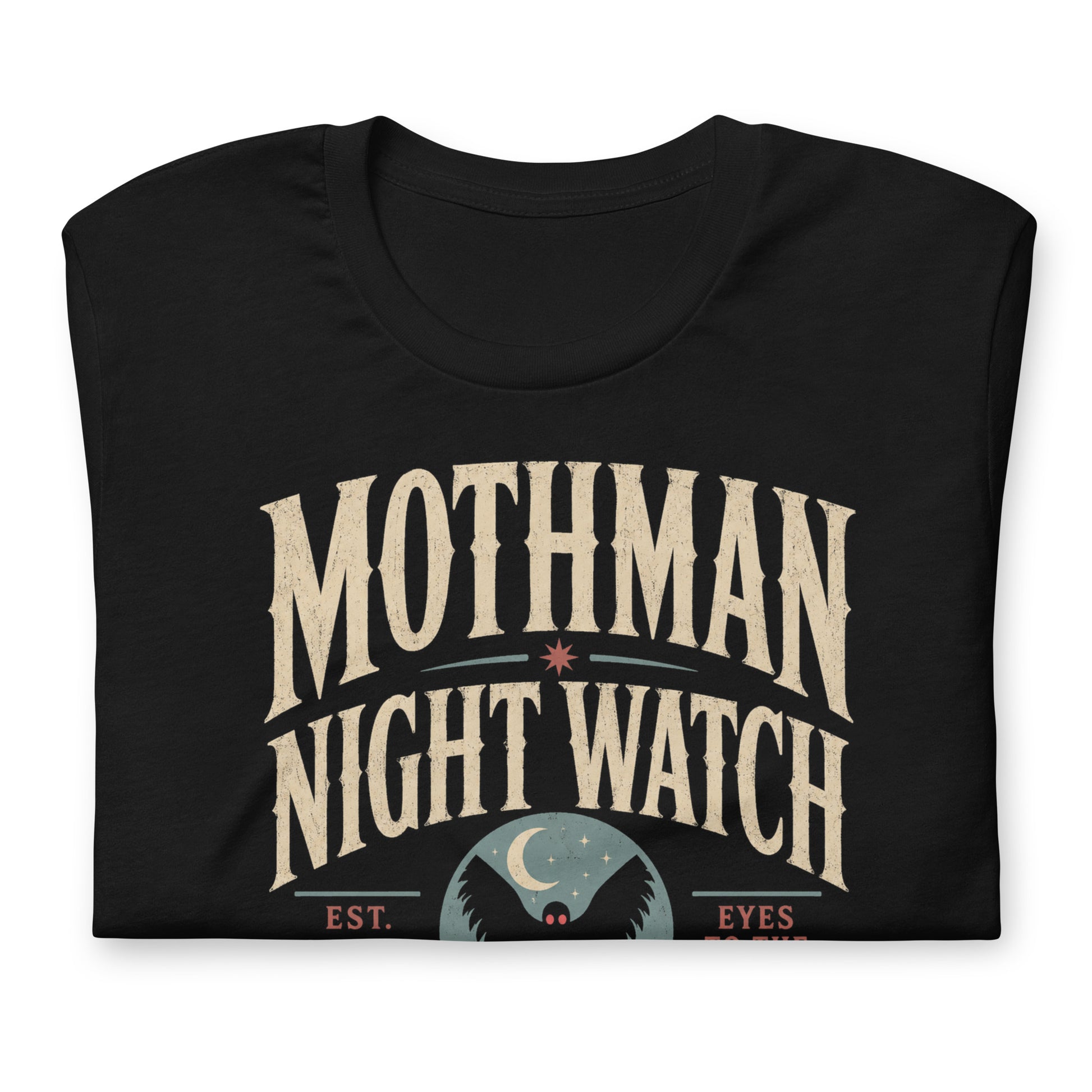 Close-up of the Mothman Night Watch original Cinderpoint Studios artwork printed on a black tee, showing distressed retro lettering, Mothman silhouette with red eyes, crescent moon, bridge scene, and Winged Incident Unit text.