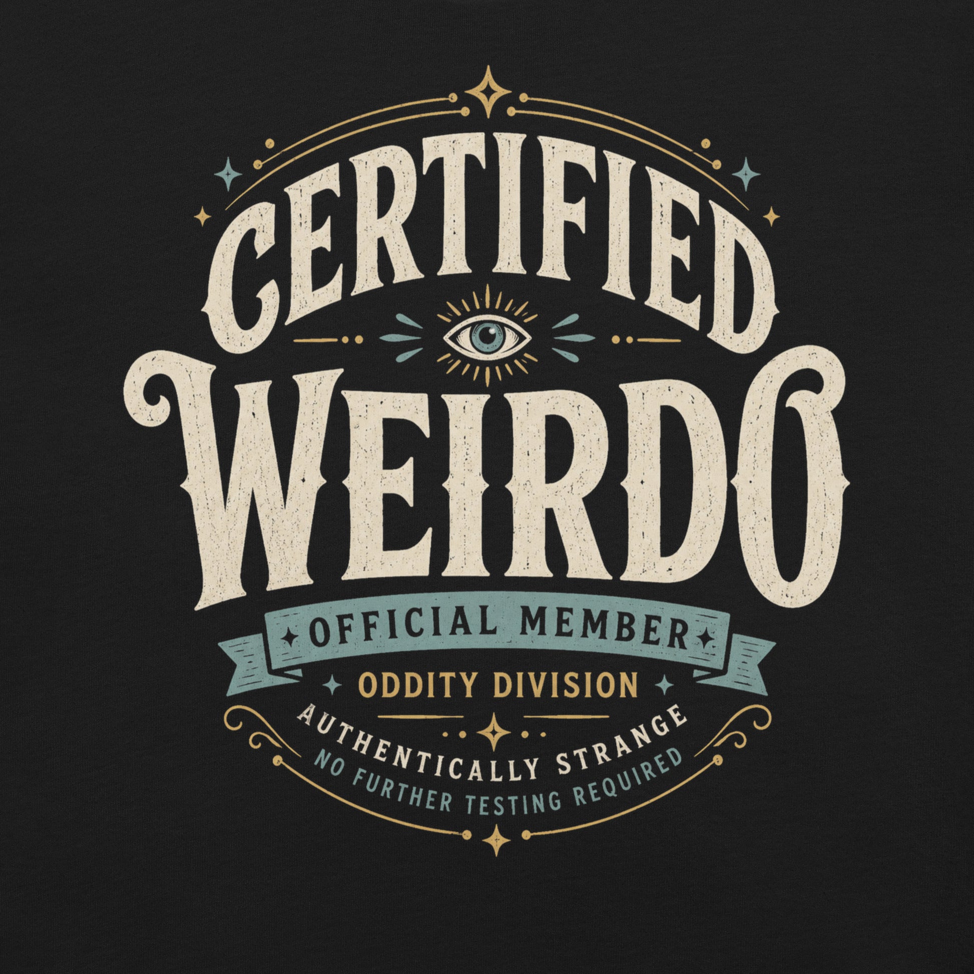 Close-up of the Certified Weirdo original Cinderpoint Studios artwork printed on a black tee, showing distressed retro lettering, all-seeing eye illustration, stars, banner details, and No Further Testing Required text.