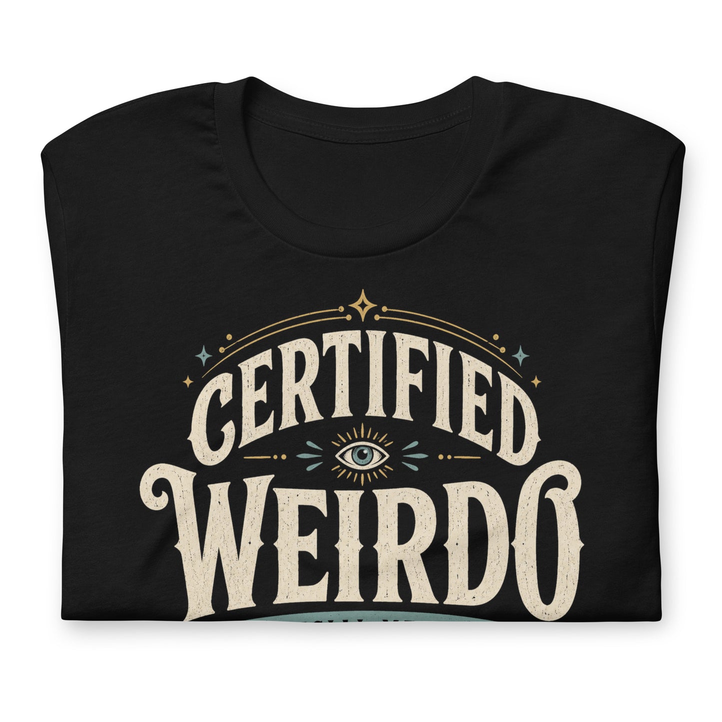 Close-up of the Certified Weirdo original Cinderpoint Studios artwork printed on a black tee, showing distressed retro lettering, all-seeing eye illustration, stars, banner details, and No Further Testing Required text.