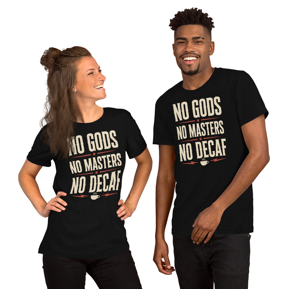 A man and a women wearing a black graphic tee with the No Gods No Masters No Decaf artwork by Cinderpoint Studios, styled as a boutique retro coffee humor shirt with bold slogan typography and red accent details.