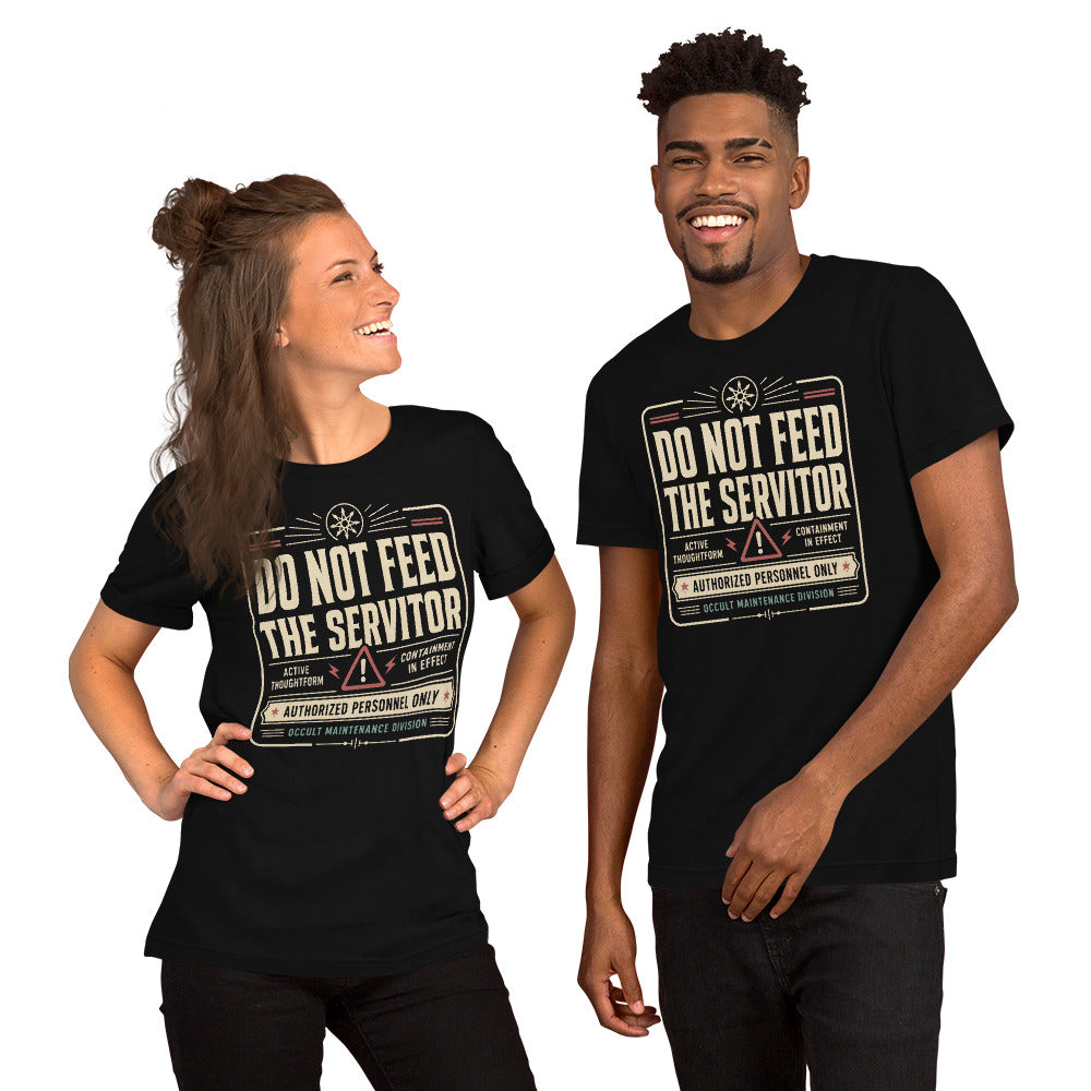 A man and a woman are wearing a black graphic tee featuring original Cinderpoint Studios artwork for Do Not Feed the Servitor, a retro occult warning-sign design with bold vintage lettering, a chaos star symbol, a hazard icon, and text including Active Thoughtform, Containment in Effect, Authorized Personnel Only, and Occult Maintenance Division.