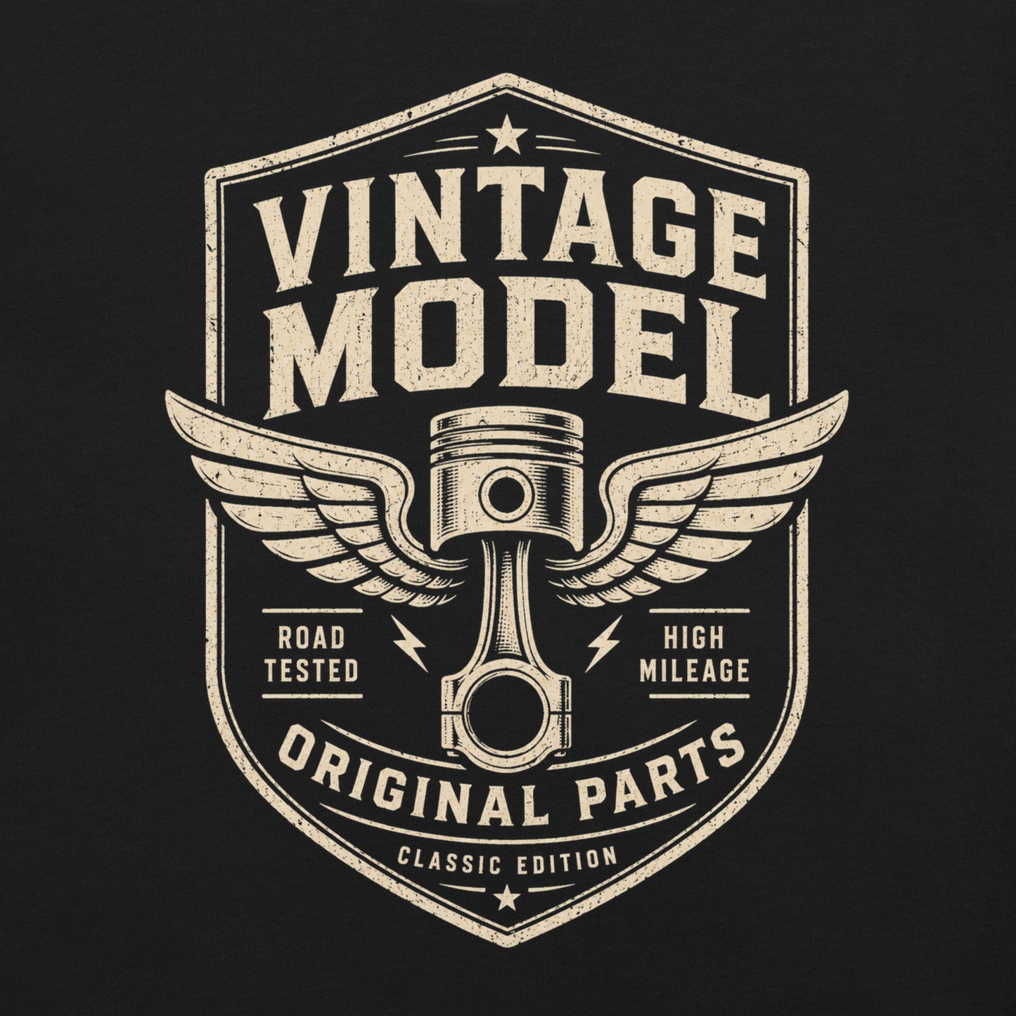 A black graphic tee featuring original Cinderpoint Studios artwork for Vintage Model, a one-color retro garage badge design with bold lettering, a winged piston, and text including Road Tested, High Mileage, Original Parts, and Classic Edition.