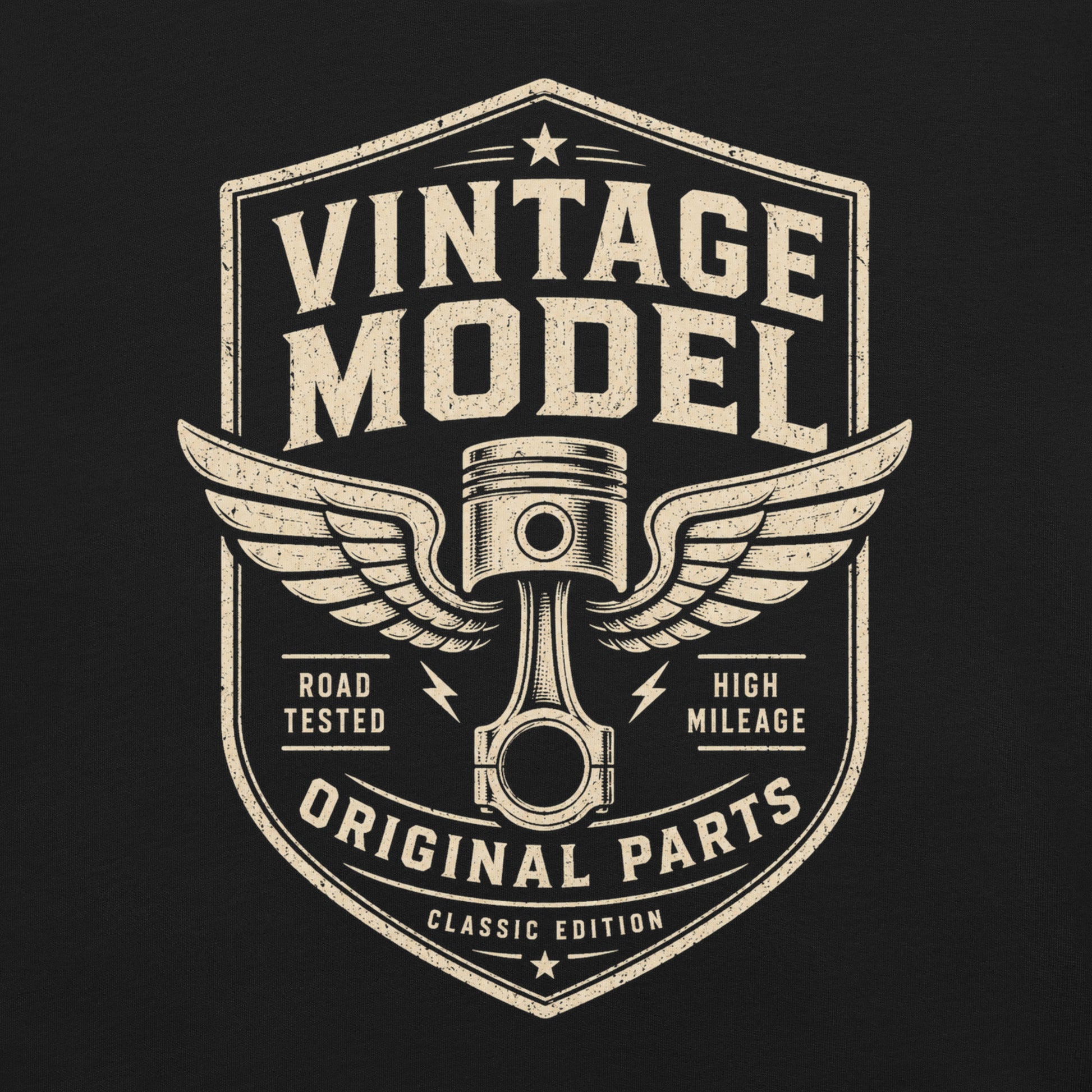 A black graphic tee featuring original Cinderpoint Studios artwork for Vintage Model, a one-color retro garage badge design with bold lettering, a winged piston, and text including Road Tested, High Mileage, Original Parts, and Classic Edition.