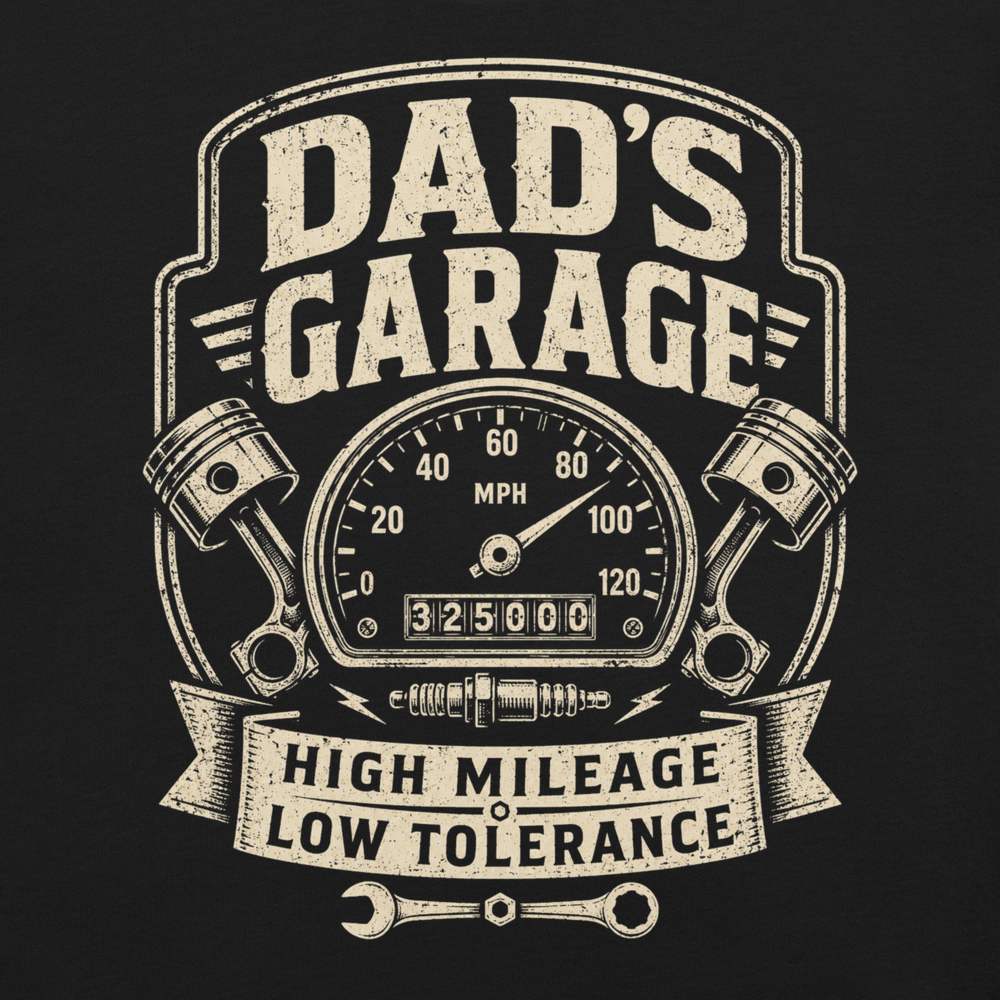 A black graphic tee featuring original Cinderpoint Studios artwork for Dad’s Garage, a one-color retro garage badge design with bold lettering, a speedometer, pistons, spark plug, wrench, and High Mileage Low Tolerance text.