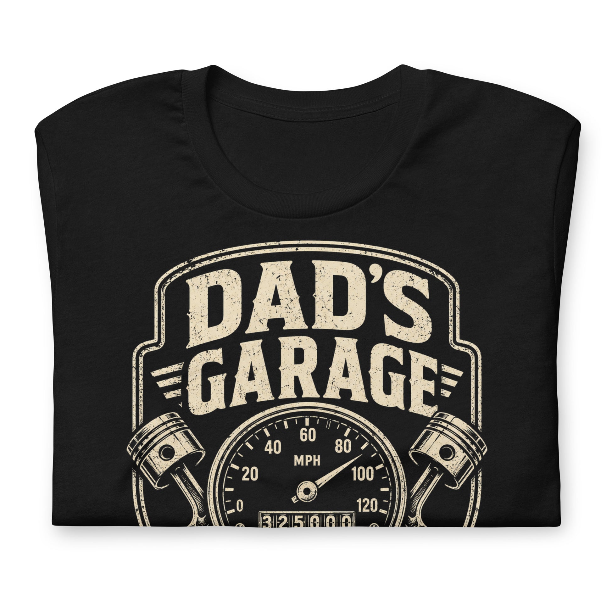 A black graphic tee featuring original Cinderpoint Studios artwork for Dad’s Garage, a one-color retro garage badge design with bold lettering, a speedometer, pistons, spark plug, wrench, and High Mileage Low Tolerance text.