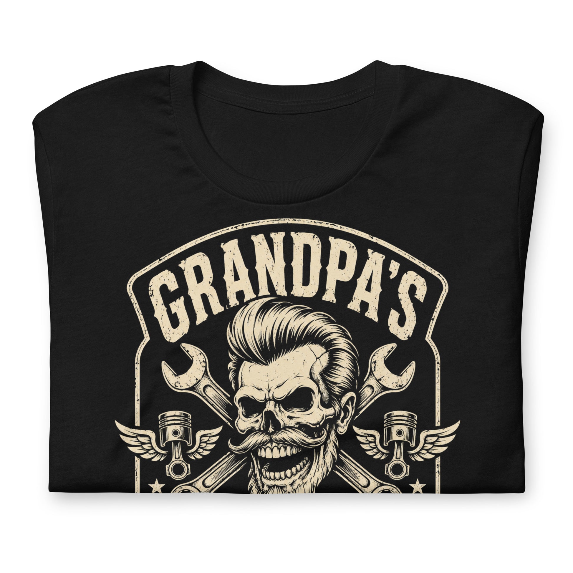 A black graphic tee featuring original Cinderpoint Studios artwork for Grandpa’s Speed Shop, a one-color retro garage design with a grinning skeletal grandpa, pompadour, mustache, crossed wrenches, winged pistons, flame accents, and No Refunds No Mercy text.