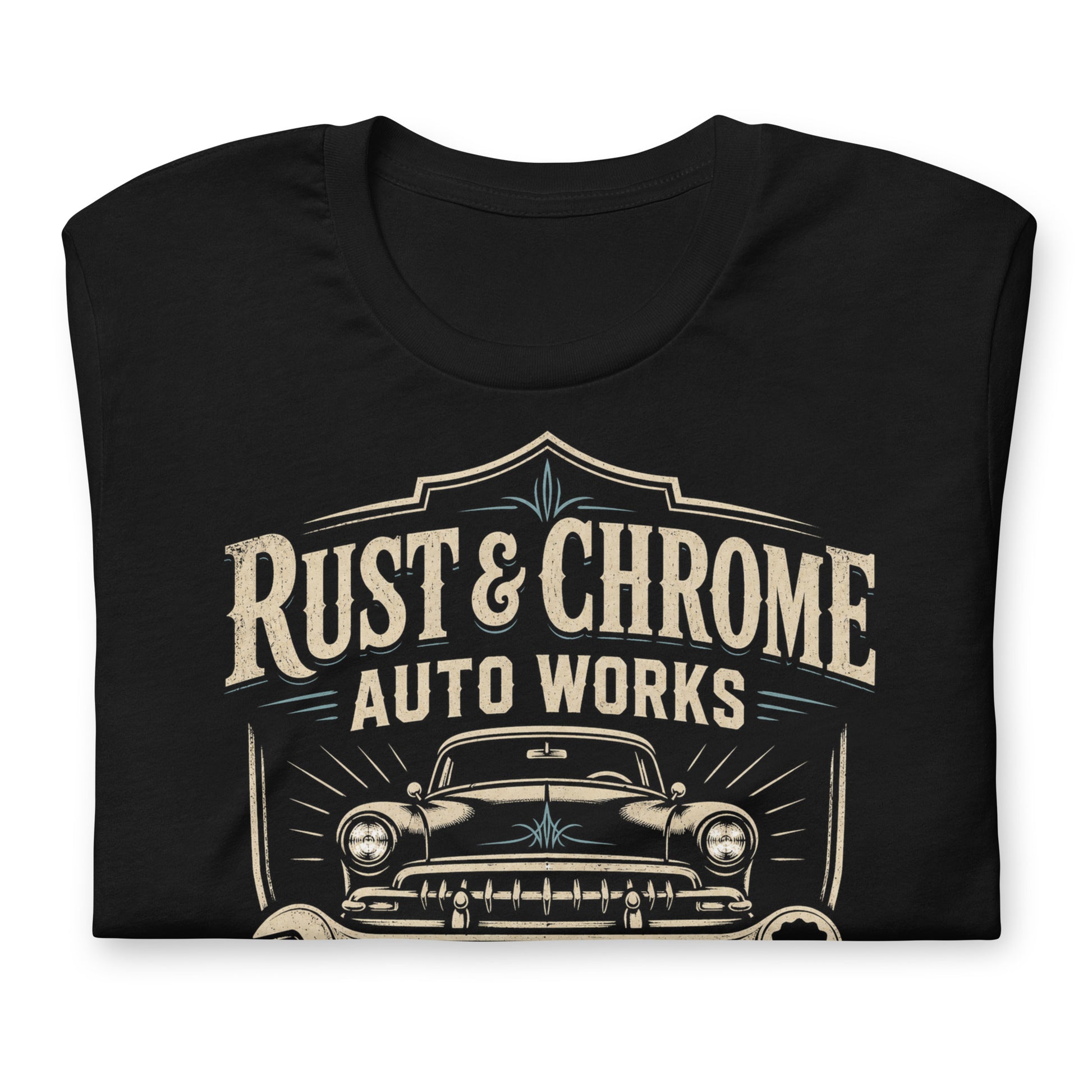 A black graphic tee featuring original Cinderpoint Studios artwork for Rust & Chrome Auto Works, a vintage garage design with a front-facing classic car, bold lettering, wrench accent, spark plug detail, restoration and custom fabrication text, and shield-style framing.