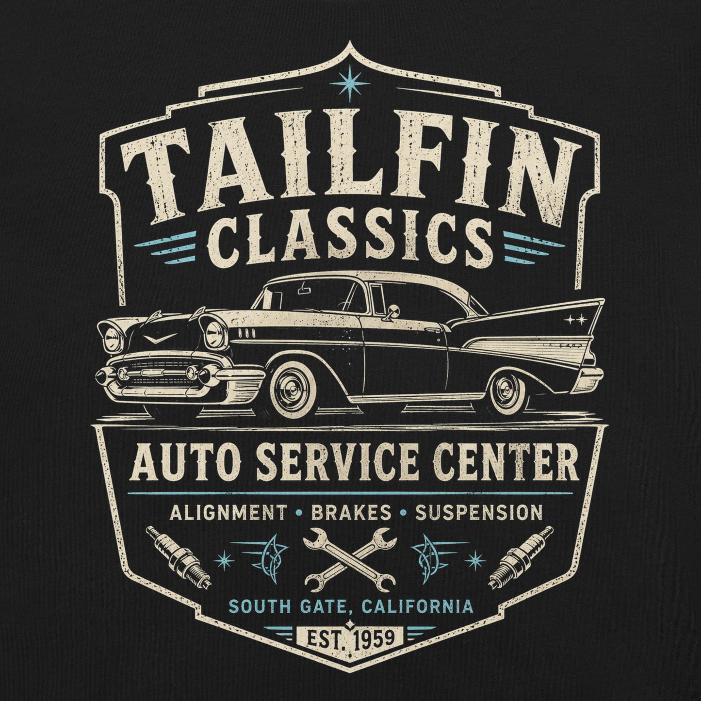 Black graphic tee featuring original Cinderpoint Studios artwork for Tailfin Classics, a retro auto service center design with a 1950s-style classic car, bold tailfins, vintage lettering, teal accents, crossed wrenches, spark plugs, and Alignment Brakes Suspension text.