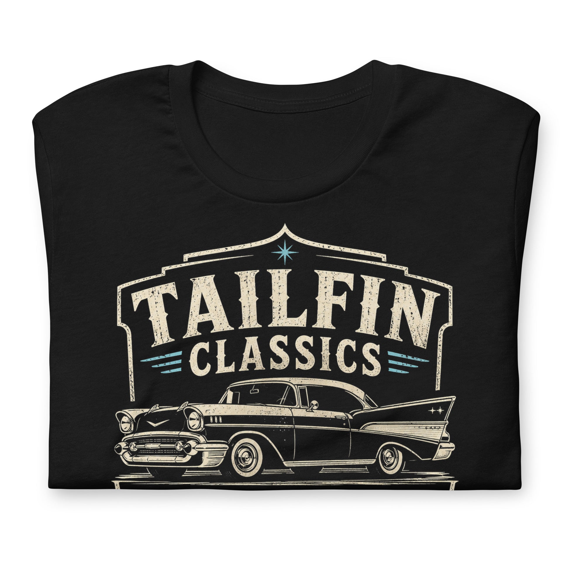 Black graphic tee featuring original Cinderpoint Studios artwork for Tailfin Classics, a retro auto service center design with a 1950s-style classic car, bold tailfins, vintage lettering, teal accents, crossed wrenches, spark plugs, and Alignment Brakes Suspension text.