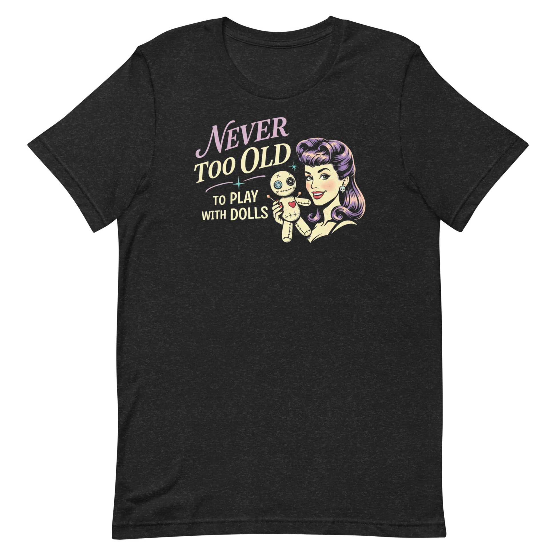 Heathered Black retro graphic t-shirt featuring the phrase Never Too Old to Play with Dolls beside a vintage-inspired woman with purple hair holding a stitched voodoo doll.