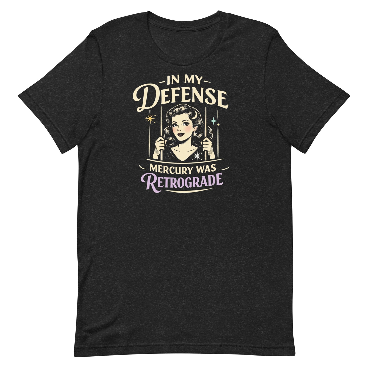 Heathered Black retro graphic t-shirt featuring a vintage-inspired woman behind bars with the phrase In My Defense Mercury Was Retrograde in cream and lavender lettering.