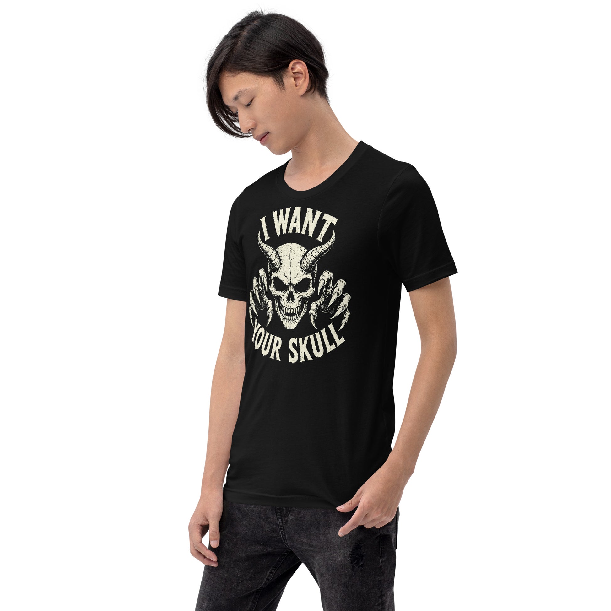 A retro-style graphic on a black t-shirt featuring a detailed horned demon skull with sharp claws and "I WANT YOUR SKULL" in distressed punk-rock lettering.
