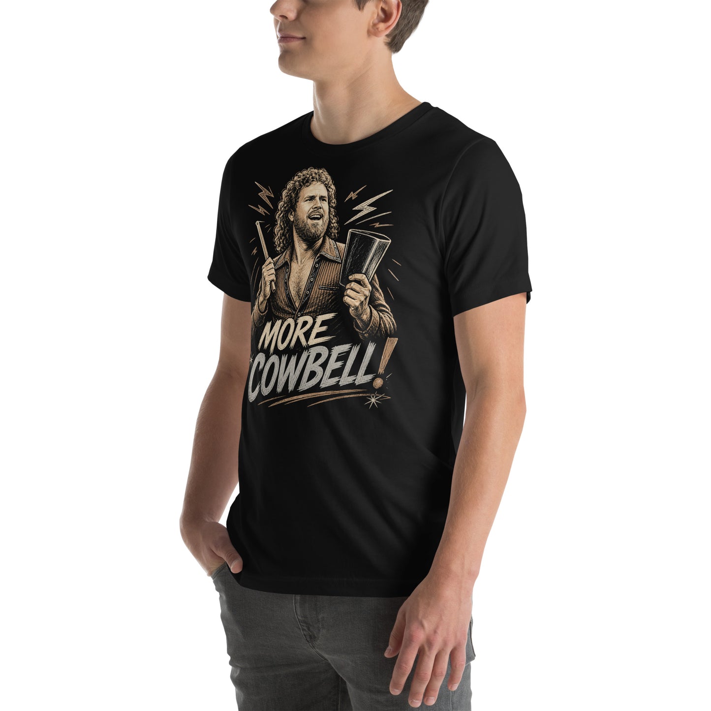 A gritty, woodcut-style illustration on a black t-shirt featuring a bearded man with curly hair and an open-collared 70s shirt holding a cowbell and drumstick, with the text 'MORE COWBELL!' in a distressed font.