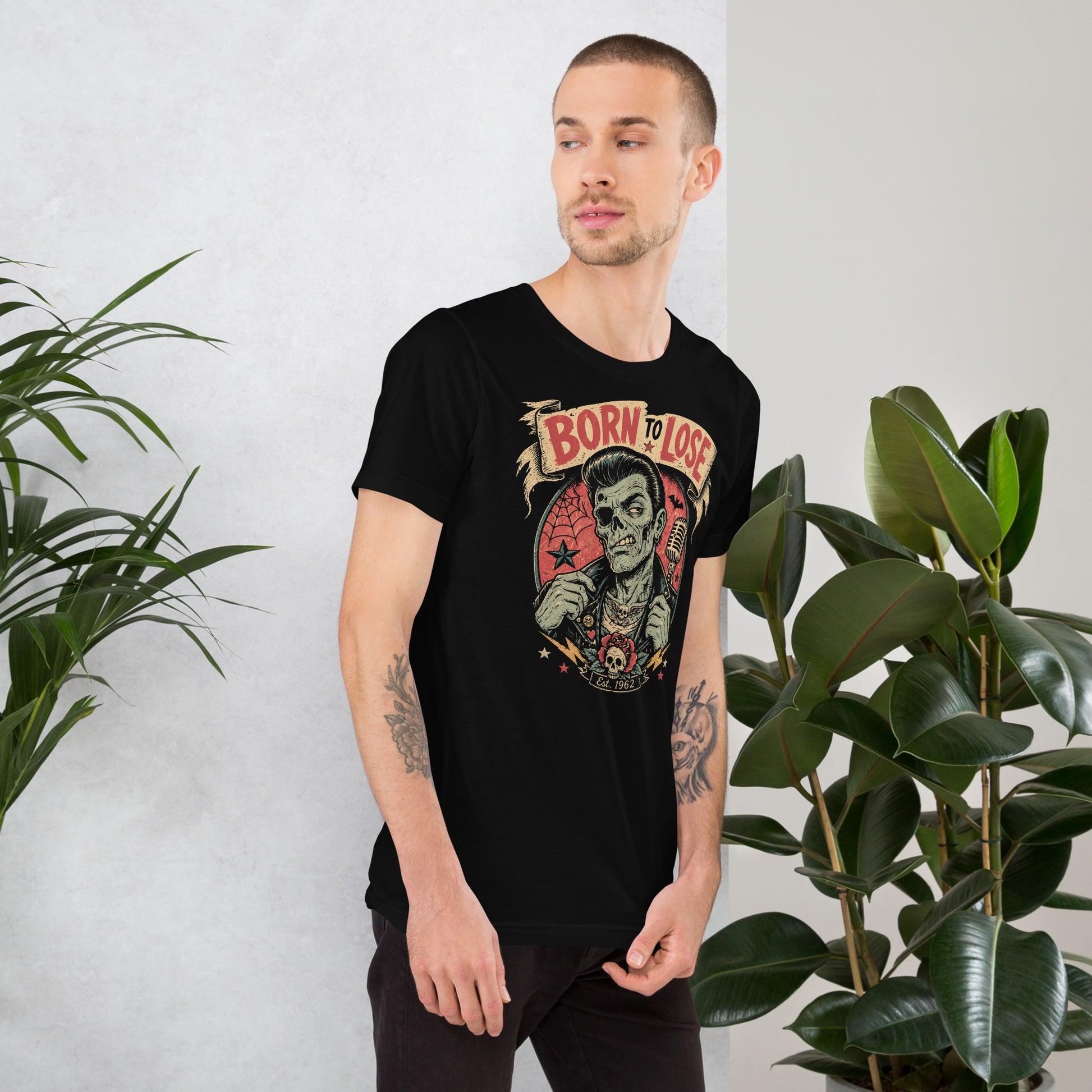 Young man wearing A vintage tattoo flash-style graphic on a black t-shirt featuring a green-skinned zombie monster with a banner that says "Born to Lose"