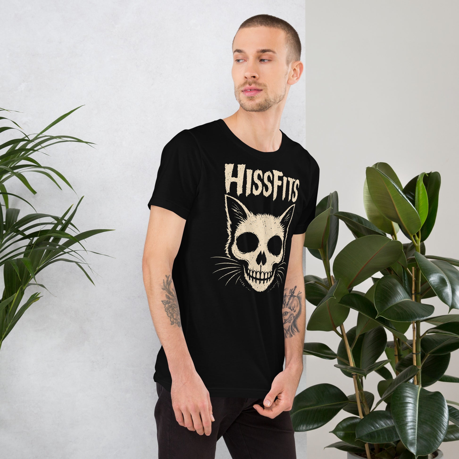 A retro horror-style graphic on a black t-shirt featuring a stylized cat skull with whiskers and pointed ears, with "HISSFITS" in iconic distressed punk-rock lettering.
