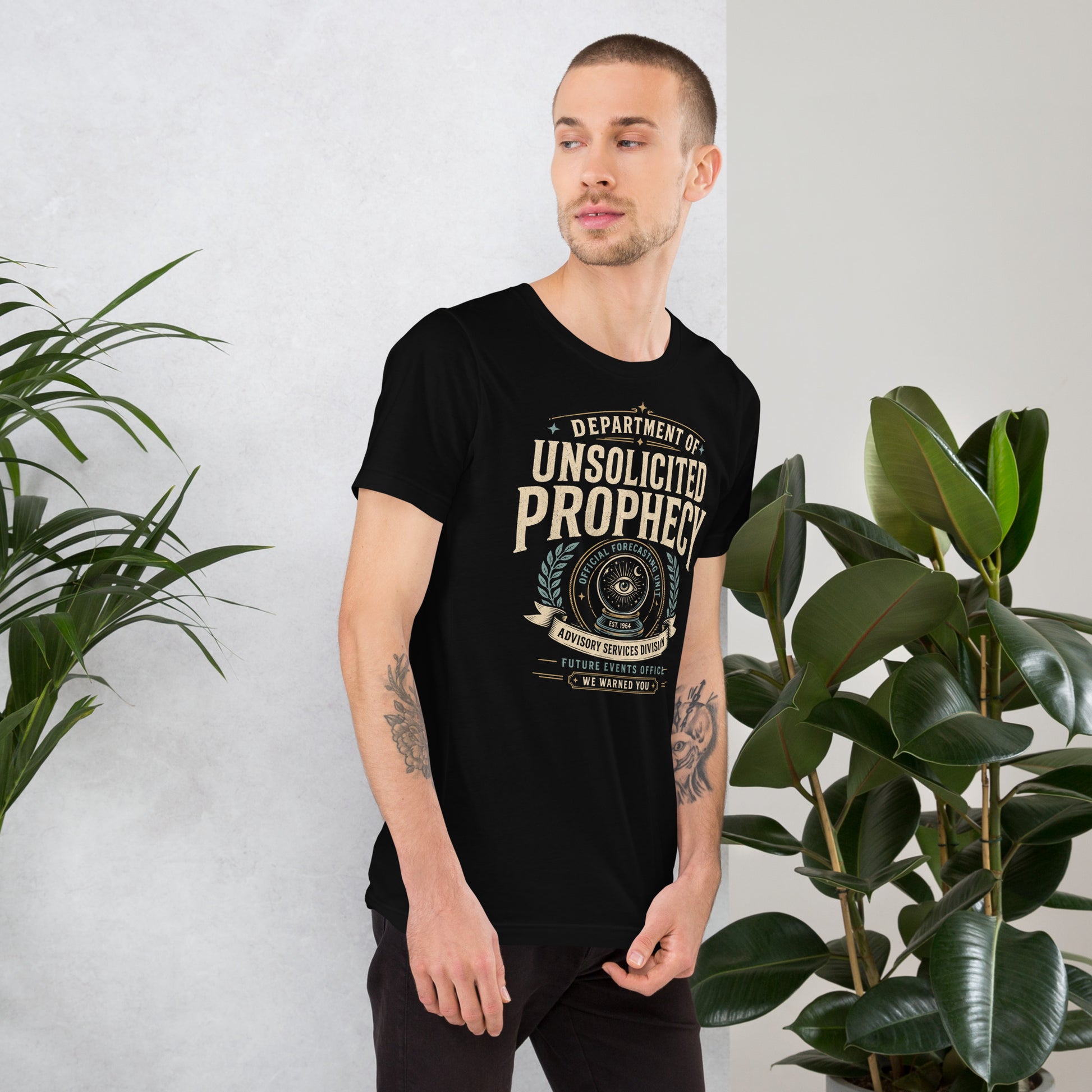Male lifestyle mockup wearing black Department of Unsolicited Prophecy t-shirt with retro occult forecasting graphic by Cinderpoint Studios